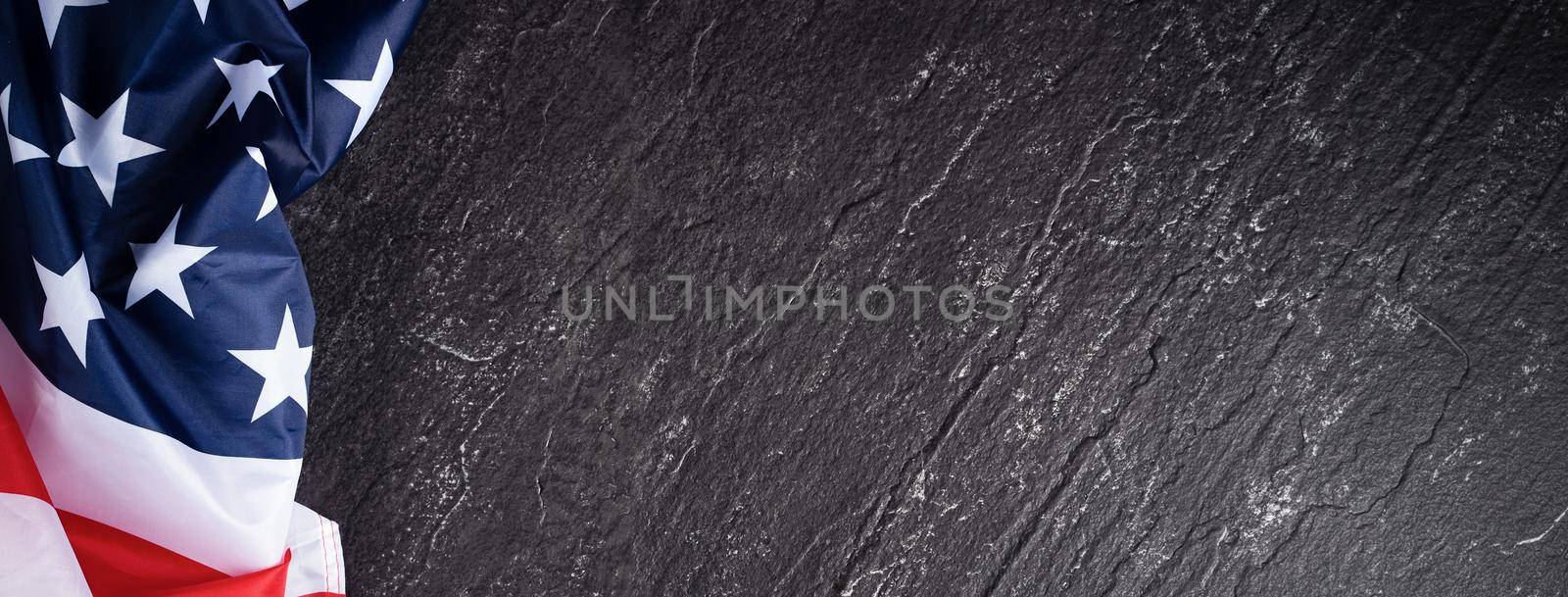 Concept of U.S Independence day or Memorial day. National flag over dark slate table background.