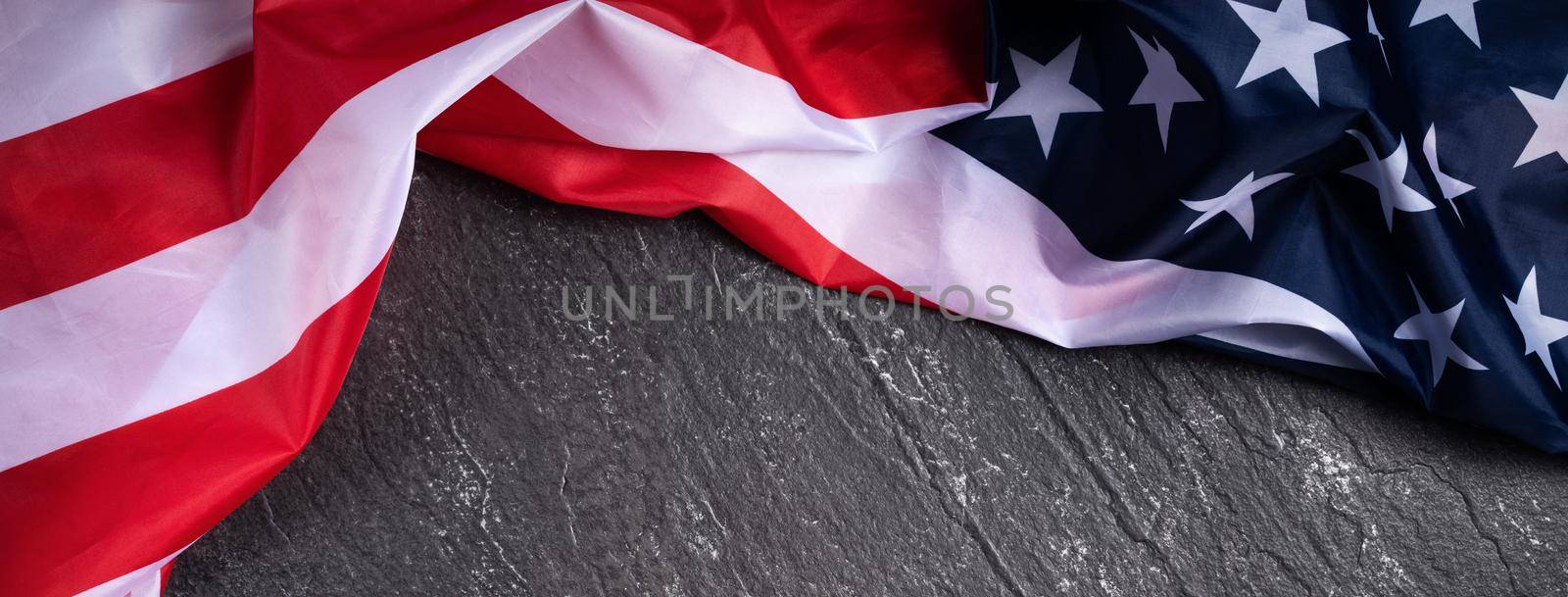 Concept of U.S Independence day or Memorial day. National flag over dark slate table background.