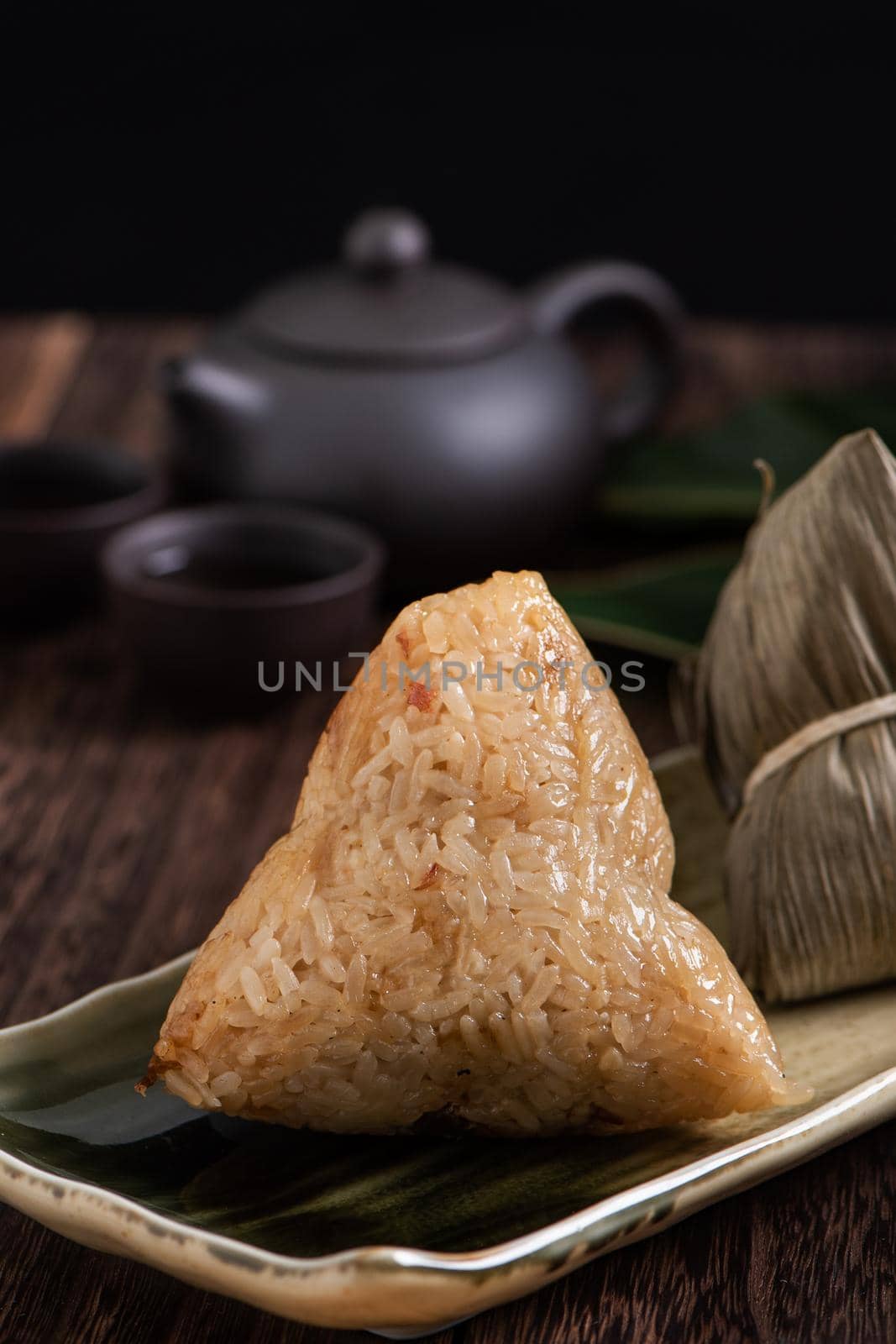 Zongzi. Rice dumpling for Dragon Boat Festival on dark wooden table background. by ROMIXIMAGE