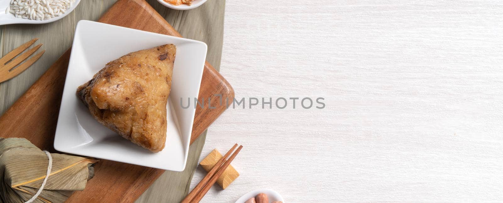 Zongzi. Delicious traditional rice dumpling food for Dragon Boat Duanwu Festival over wooden table background top view.