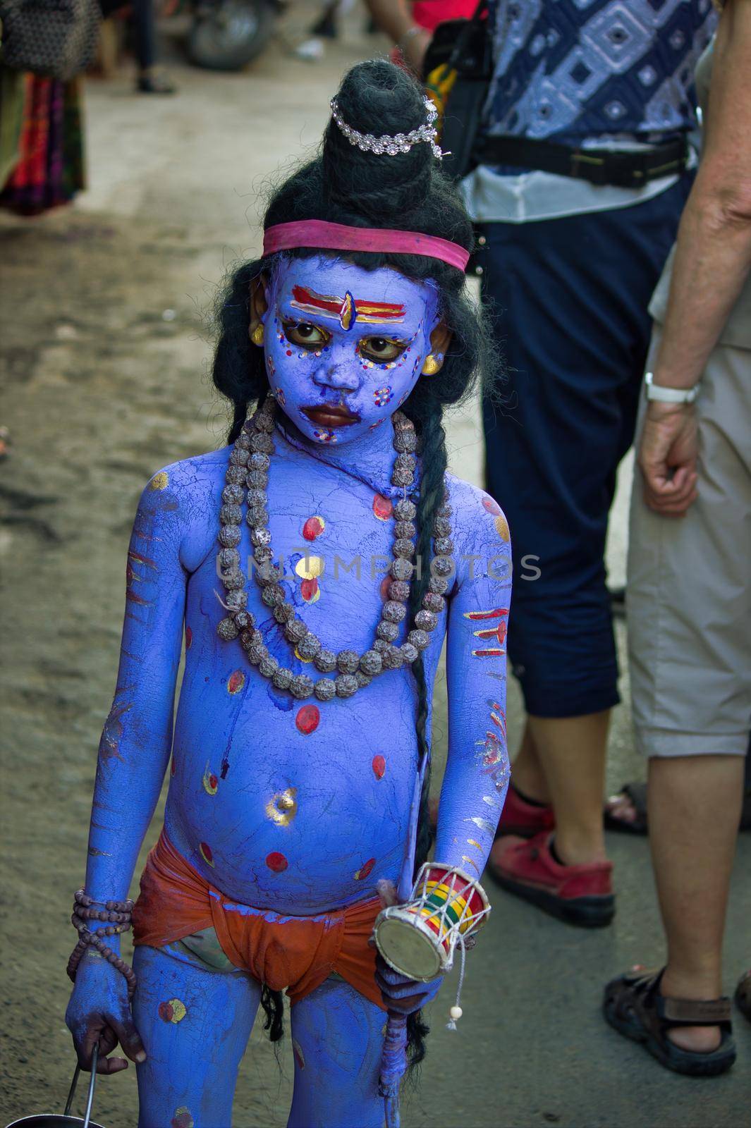 Pushkar, India - November 10, 2016: An unidentified boy dressed and disguised as hindu Lord Shiva with blue paint attends the Pushkar cattle fair in the state of Rajasthan by arpanbhatia