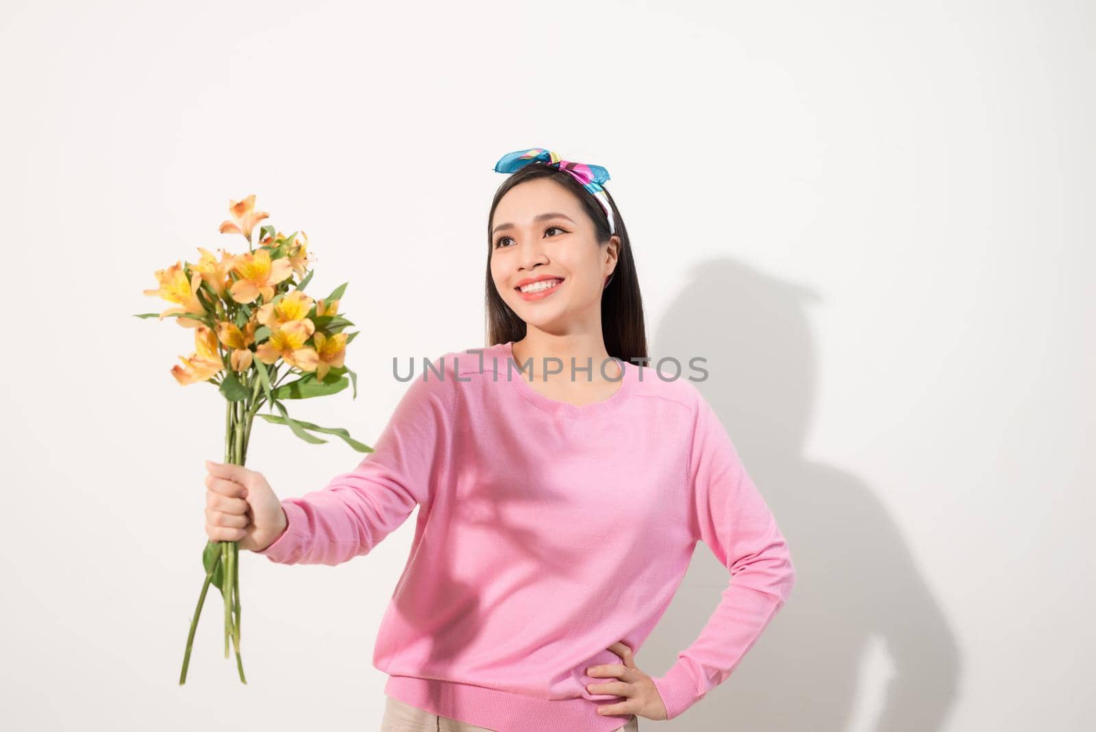 Lifestyle leisure international women's day concept. Close up portrait of lovely cute adorable excited delightful attractive woman holding flowers isolated on white background by makidotvn