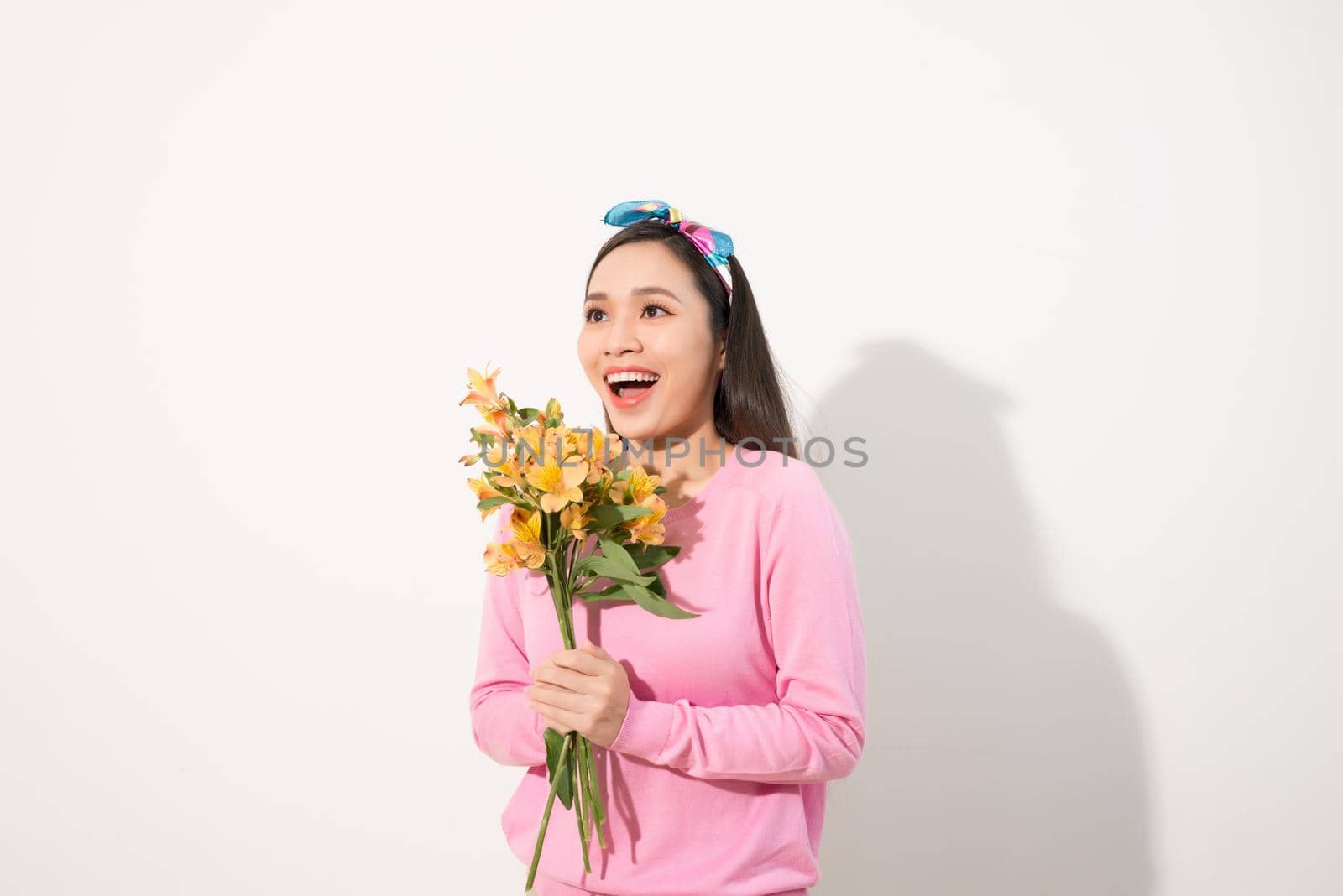 Lifestyle leisure international women's day concept. Close up portrait of lovely cute adorable excited delightful attractive woman holding flowers isolated on white background