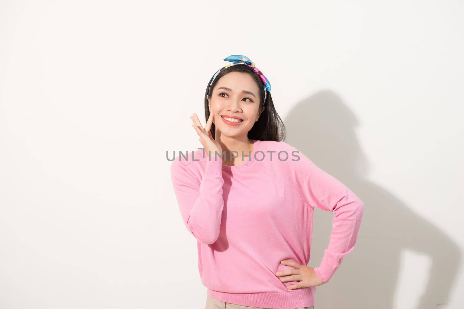 Asian woman touching her face with joy, nice smile, happy and bright feeling, white background