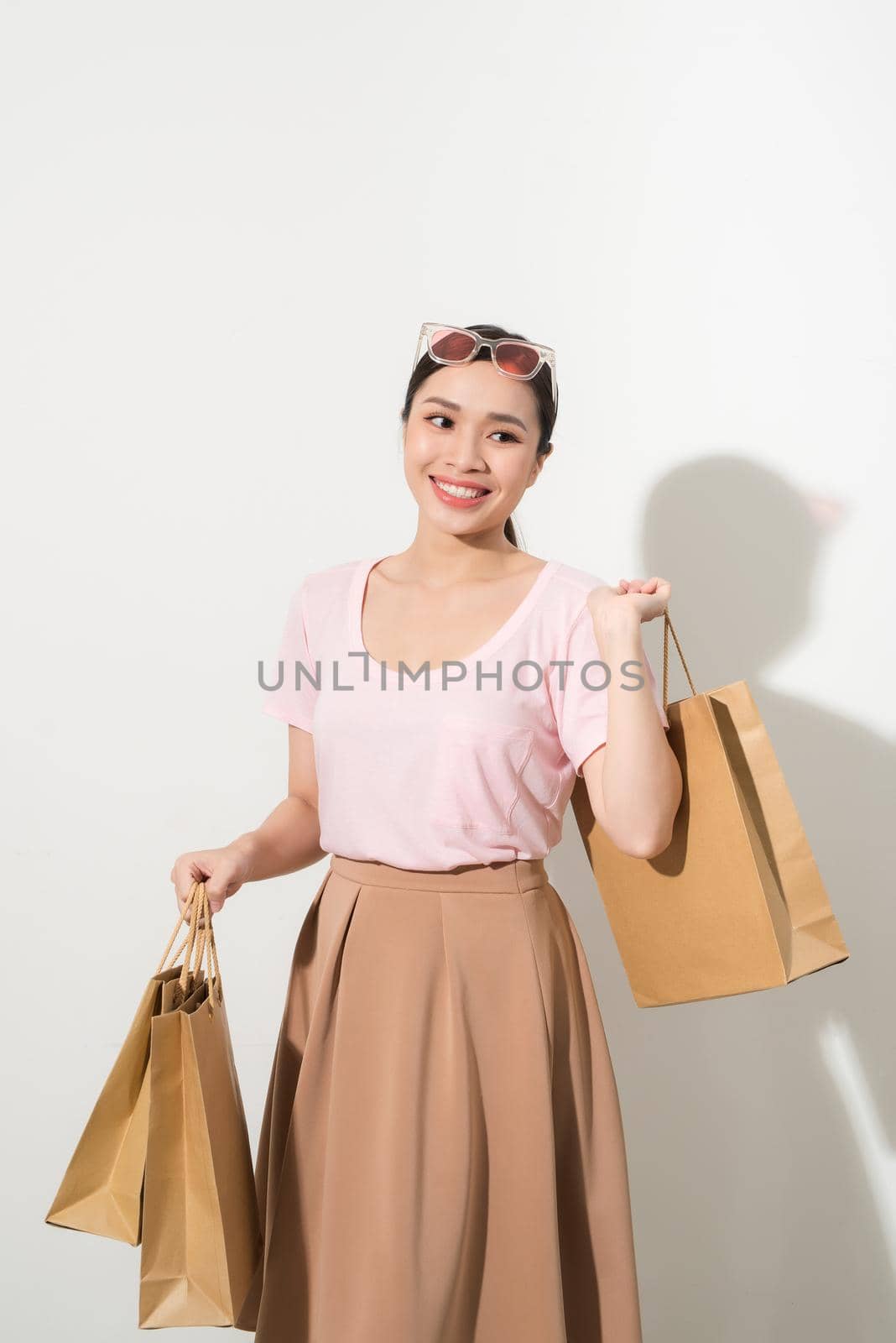 young woman with purchases on a white background, fashion, beauty