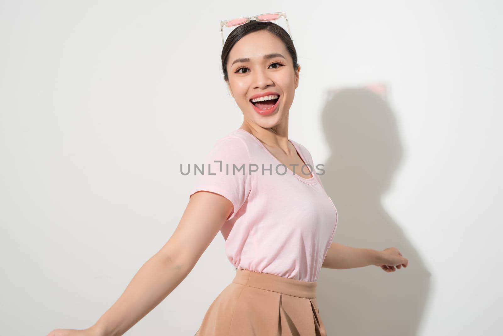 Magnificent girl dancing with smile in white studio. Indoor portrait of inspired caucasian lady in romantic outfit expressing happy emotions.