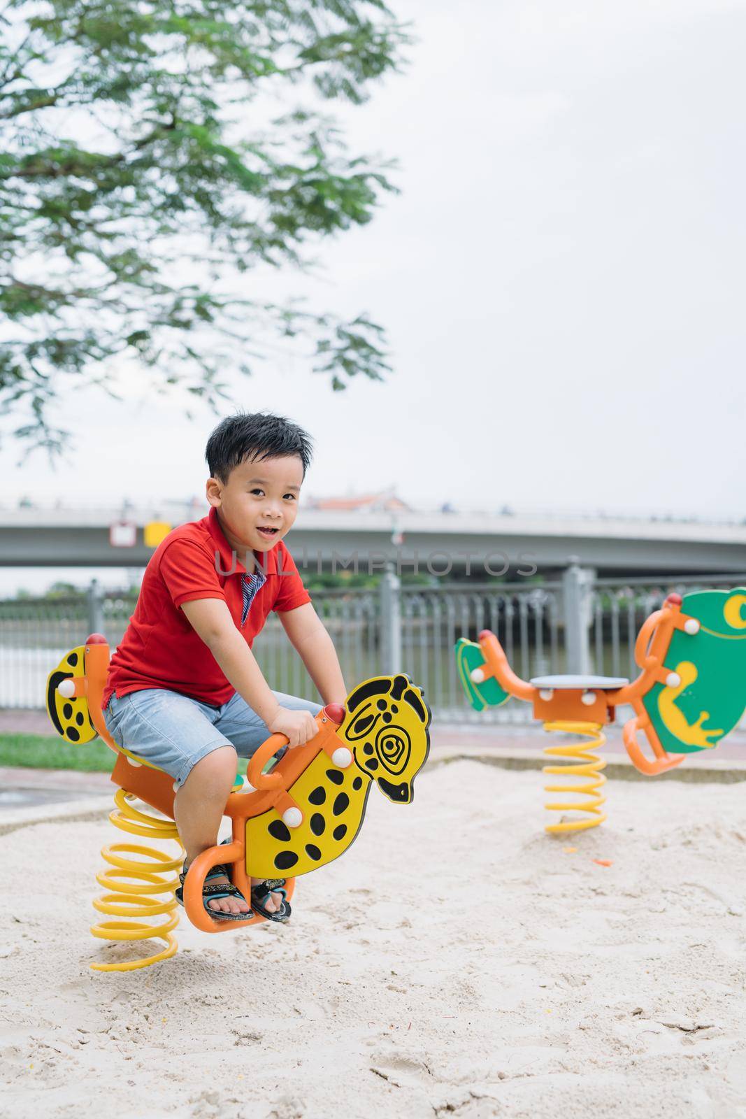 children playing on playground in summer outdoor park