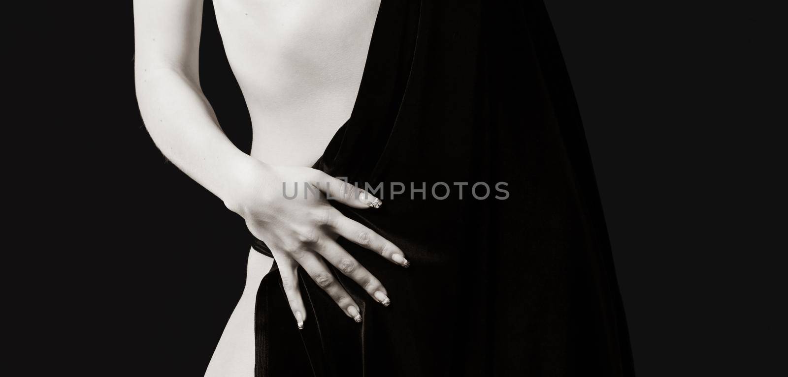 Elegant woman and beauty concept. Half-naked woman posing in the studio. View from the back