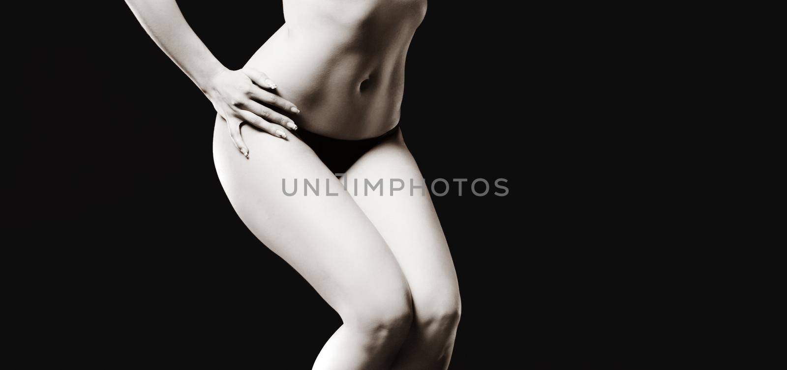 Elegant woman and beauty concept. Half-naked woman posing in the studio. View from the back