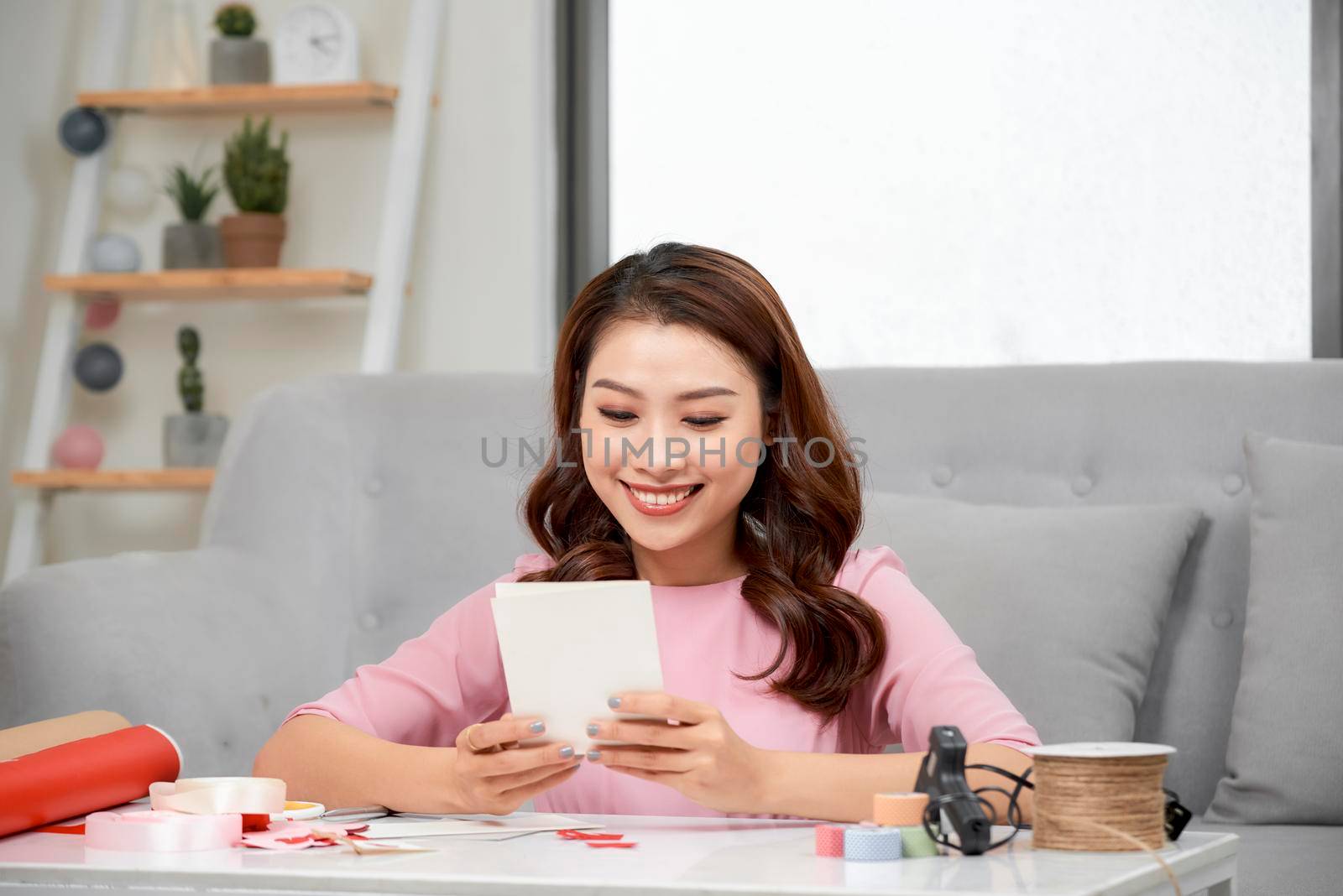 Valentine day theme. Beautiful romantic woman making present for her couple