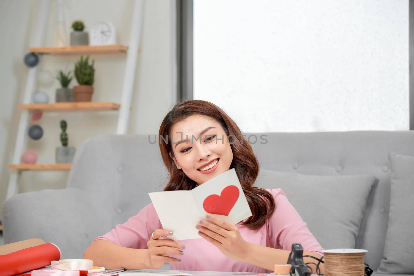 Valentine day theme. Beautiful romantic woman making present for her couple