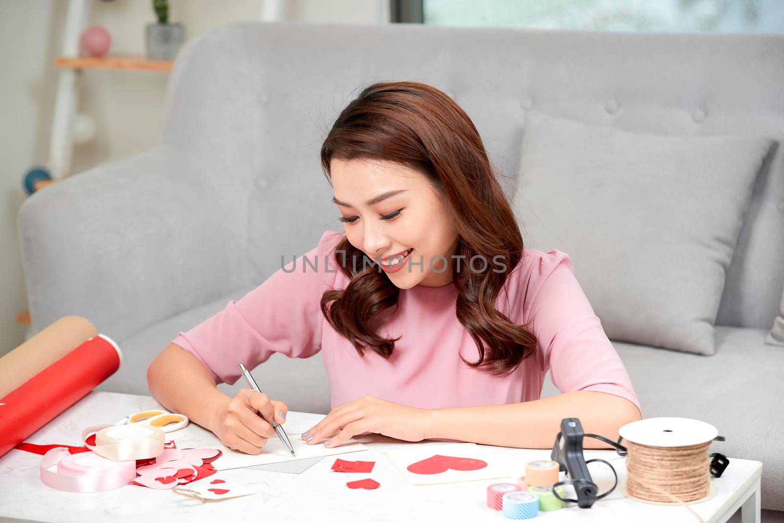 Valentine day theme. Beautiful romantic woman making present for her couple