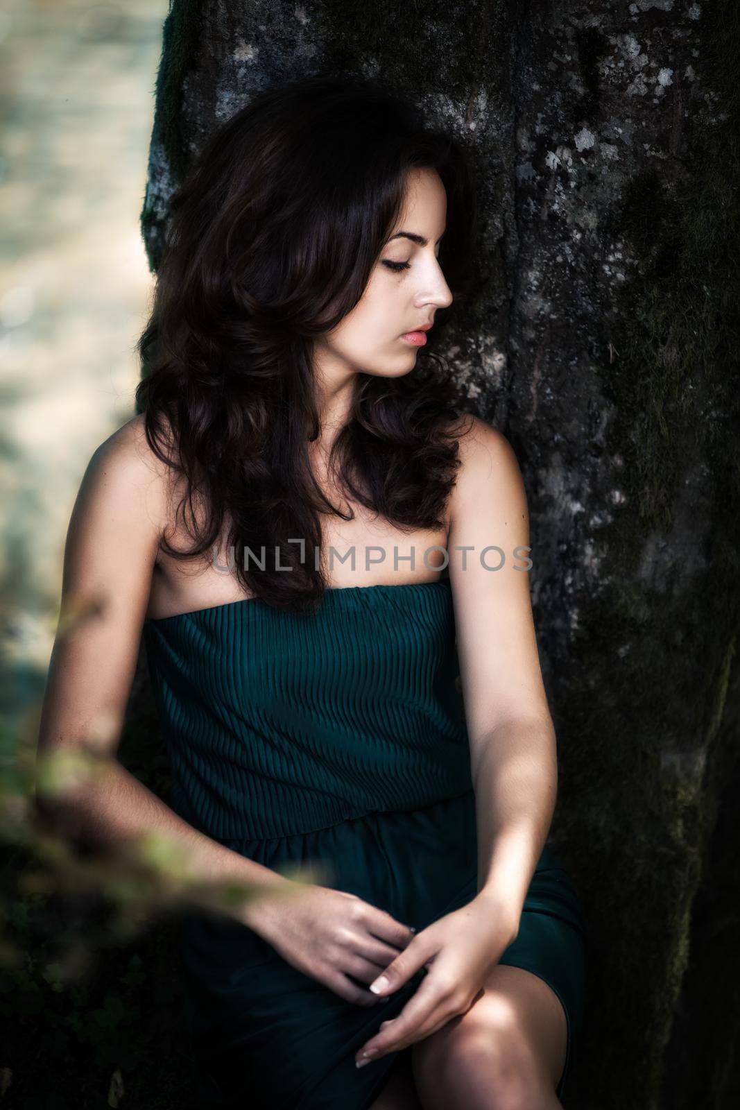 Beautiful sensual young woman in the wood near the river