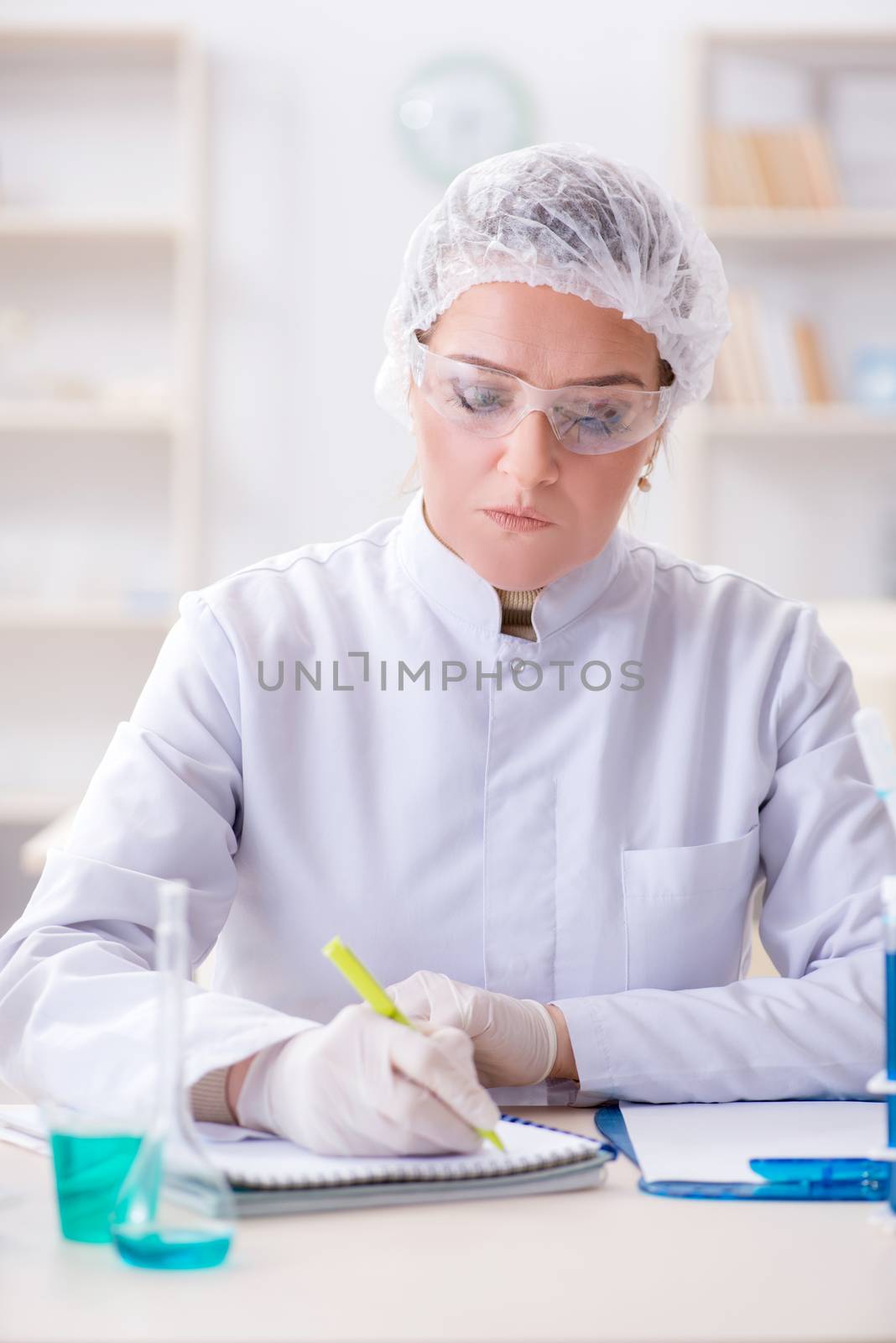 Woman chemist working in hospital clinic lab