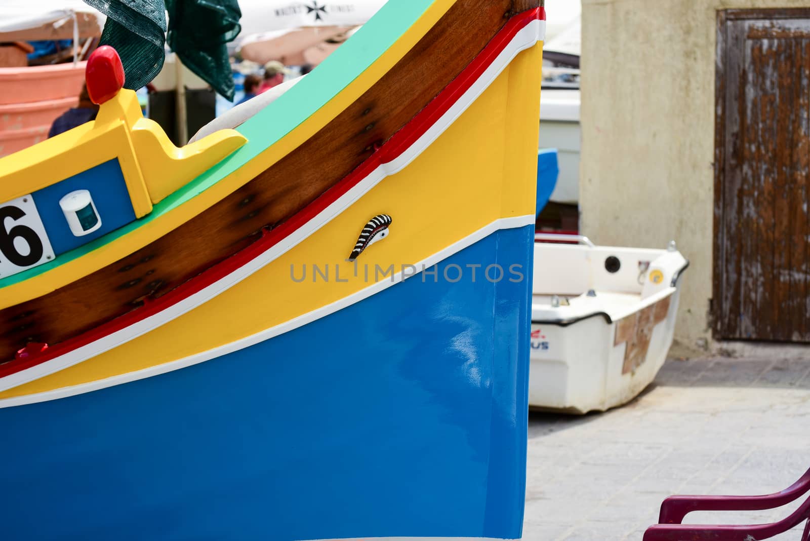 Traditional eyed colorful boats Luzzu in the Harbor of Mediterranean fishing village Marsaxlokk, Malta