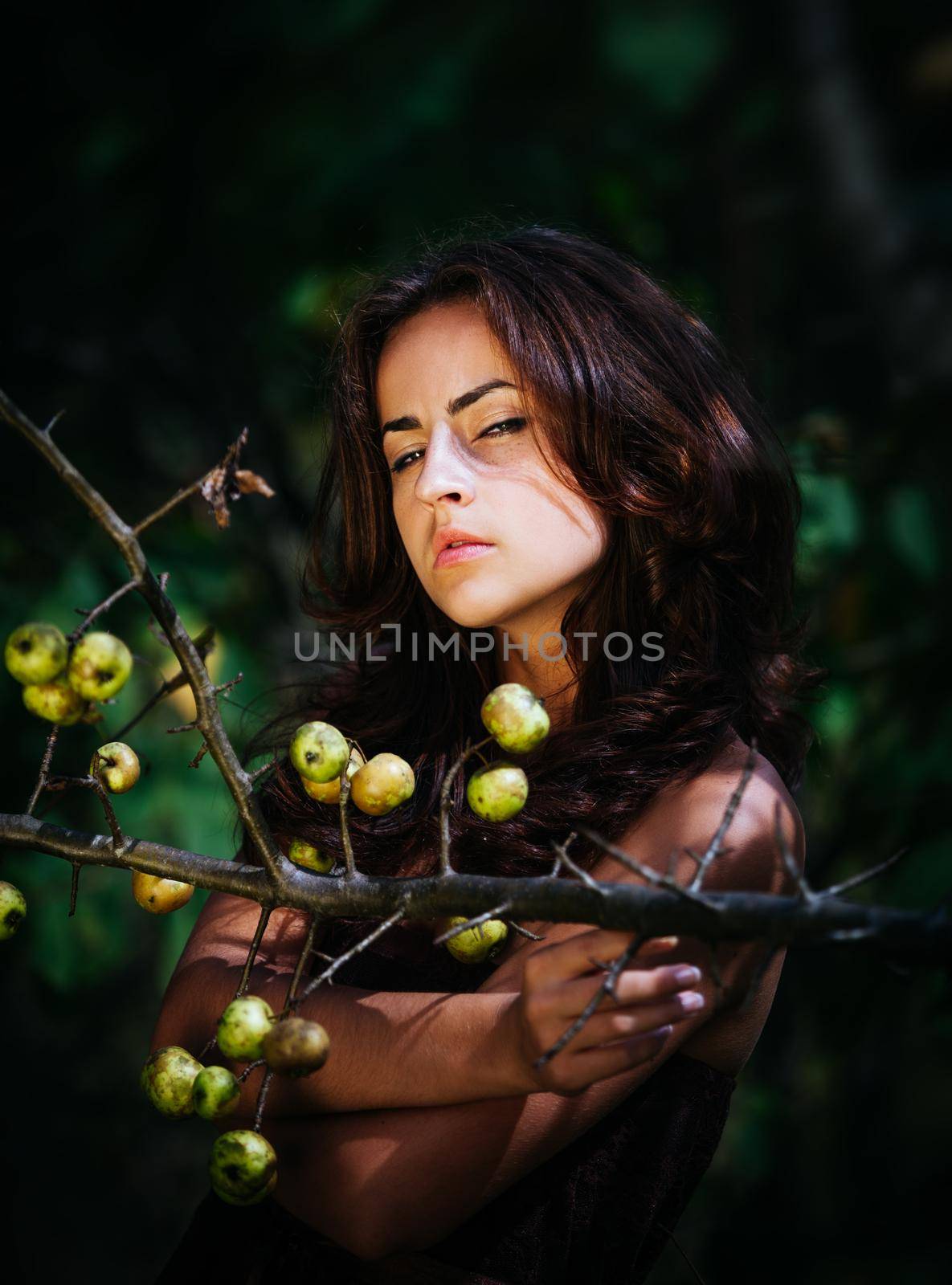 Soft portrait of young woman with wild apples