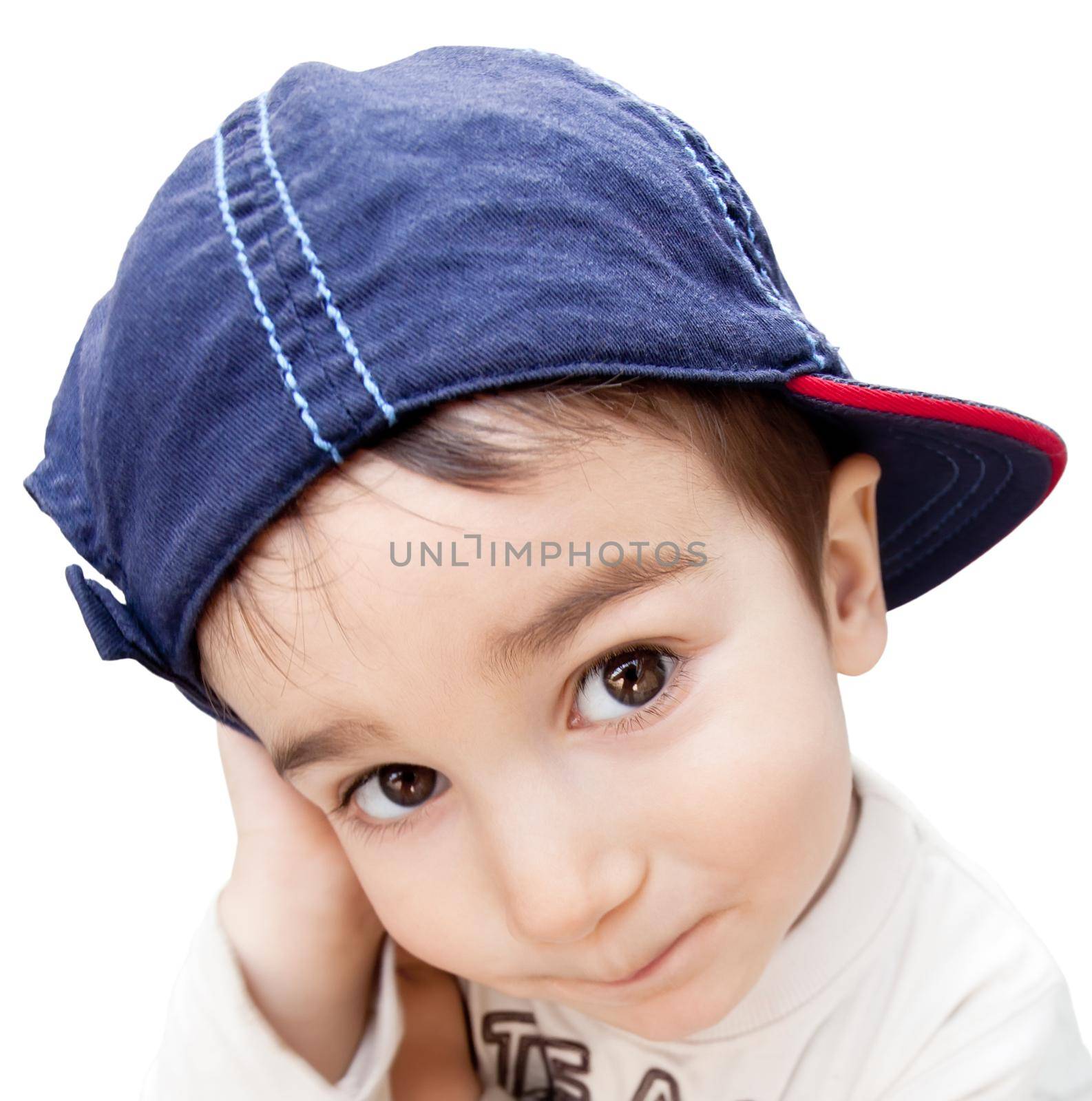 Portrait of a little boy with cunning eyes wearing a cap