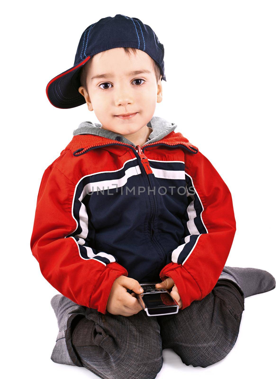 Little boy with cell phone and cap on white background