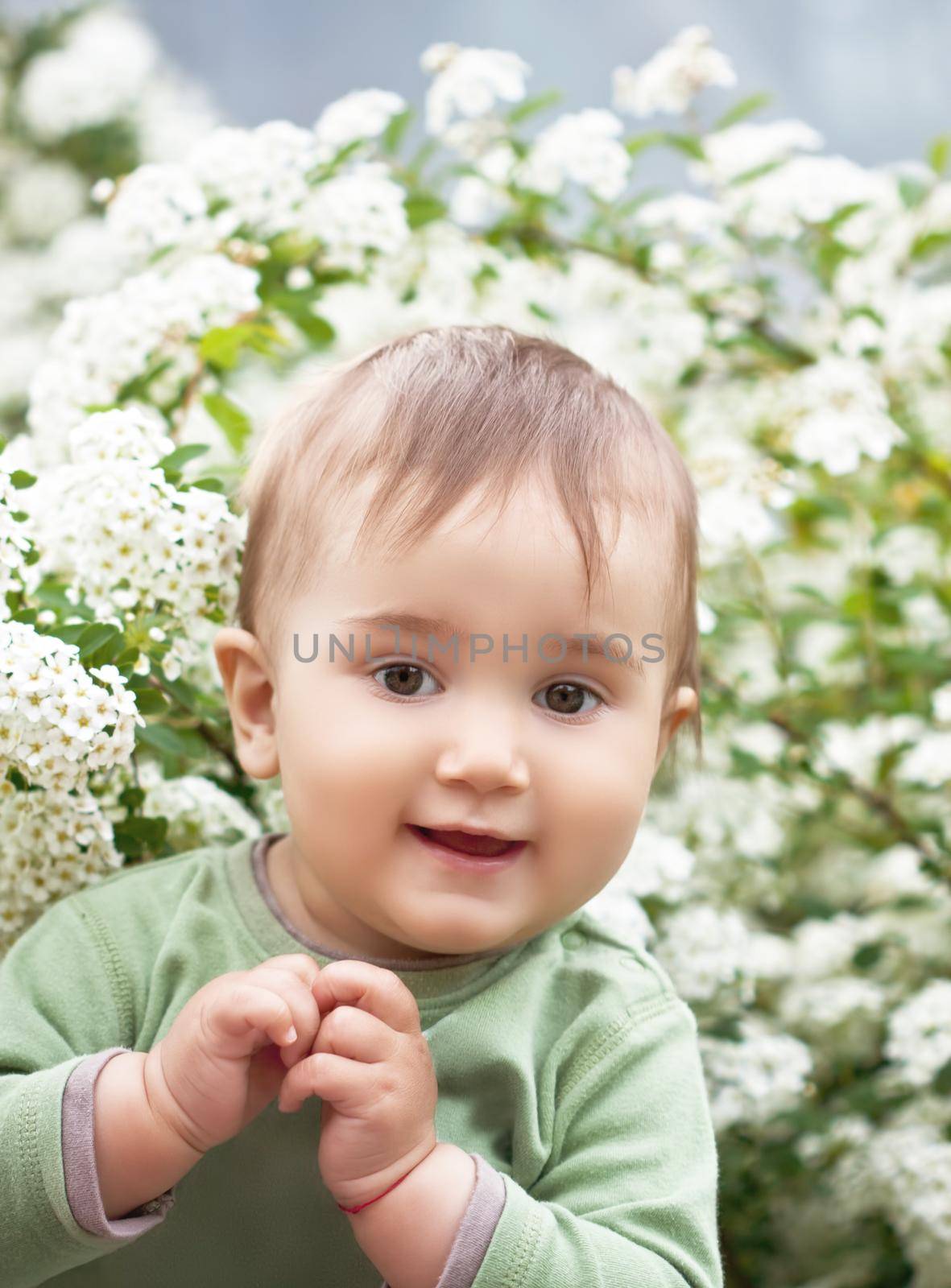 A little boy in the spring among the flowers