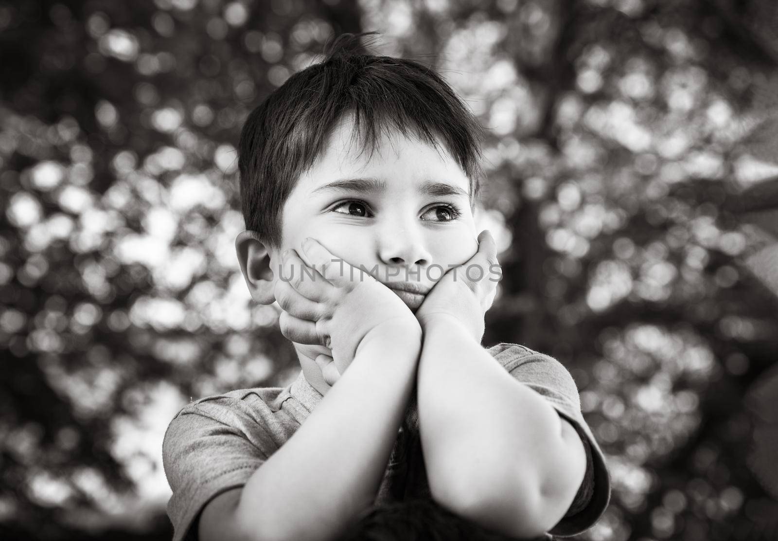 Family and happy lifestyle concept. Portrait of a little boy on the background of a blurred cityscape. 