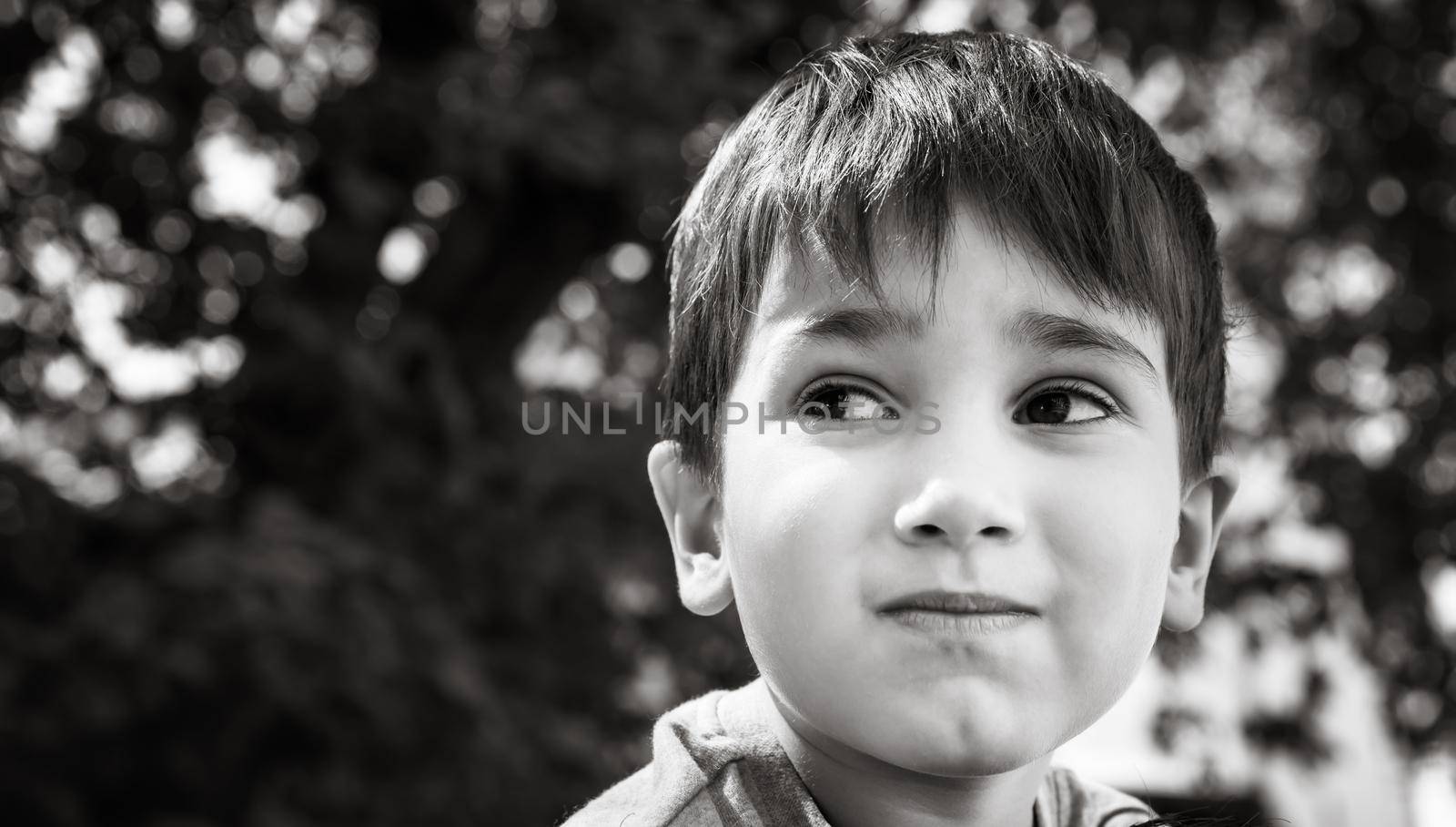 Family and happy lifestyle concept. Portrait of a little boy on the background of a blurred cityscape. 