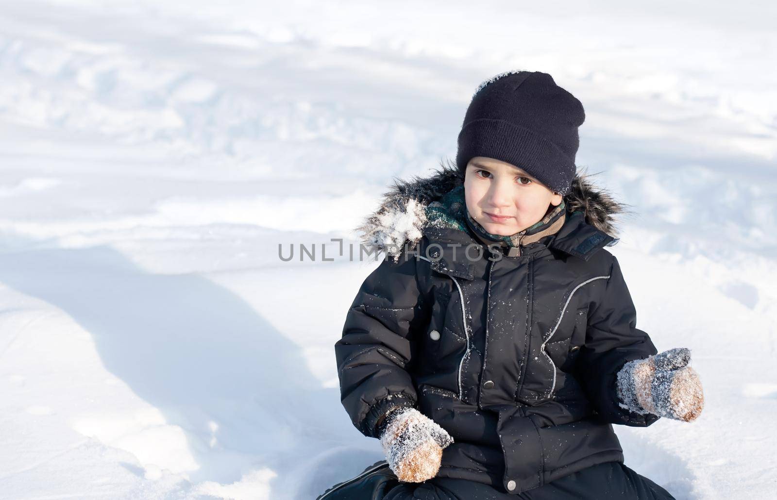 Happy boy playing in snow by palinchak