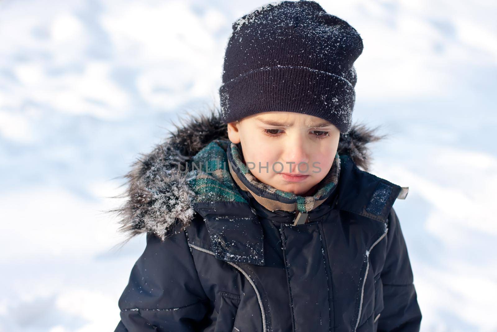 Winter portrait of  boy in snow background