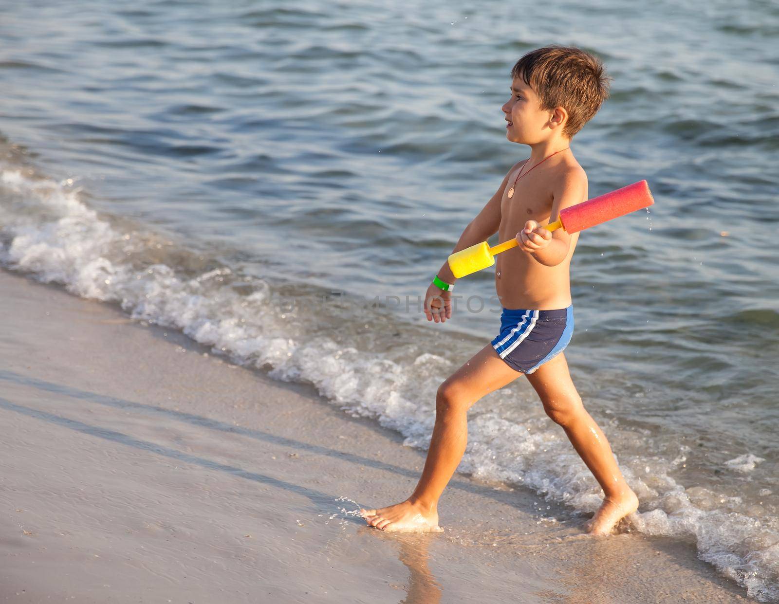 little boy walking by the sea by palinchak