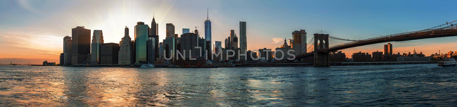 NEW YORK, USA - May 01, 2016: Panorama of Manhattan Skyline and Brooklyn Bridge during sunset seen from Brooklyn Bridge Park