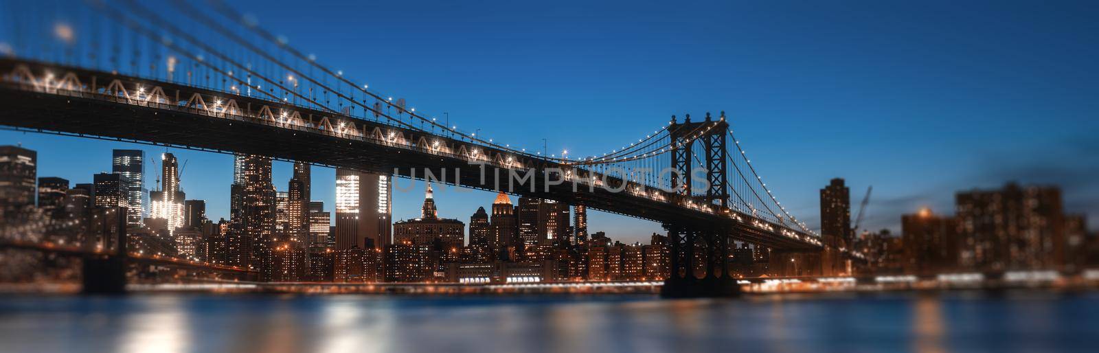 Manhattan Skyline and Manhattan Bridge At Night. Defocused image with blurred edges and  foreground. Romantic view with lights and bokeh