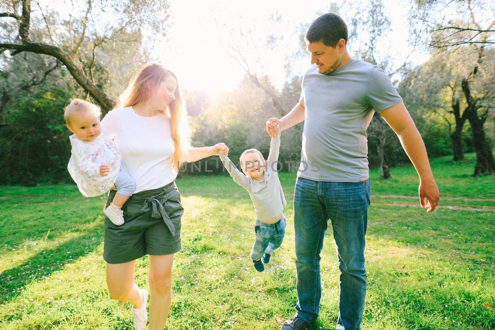 Family is having fun in the park on a sunny day. High quality photo
