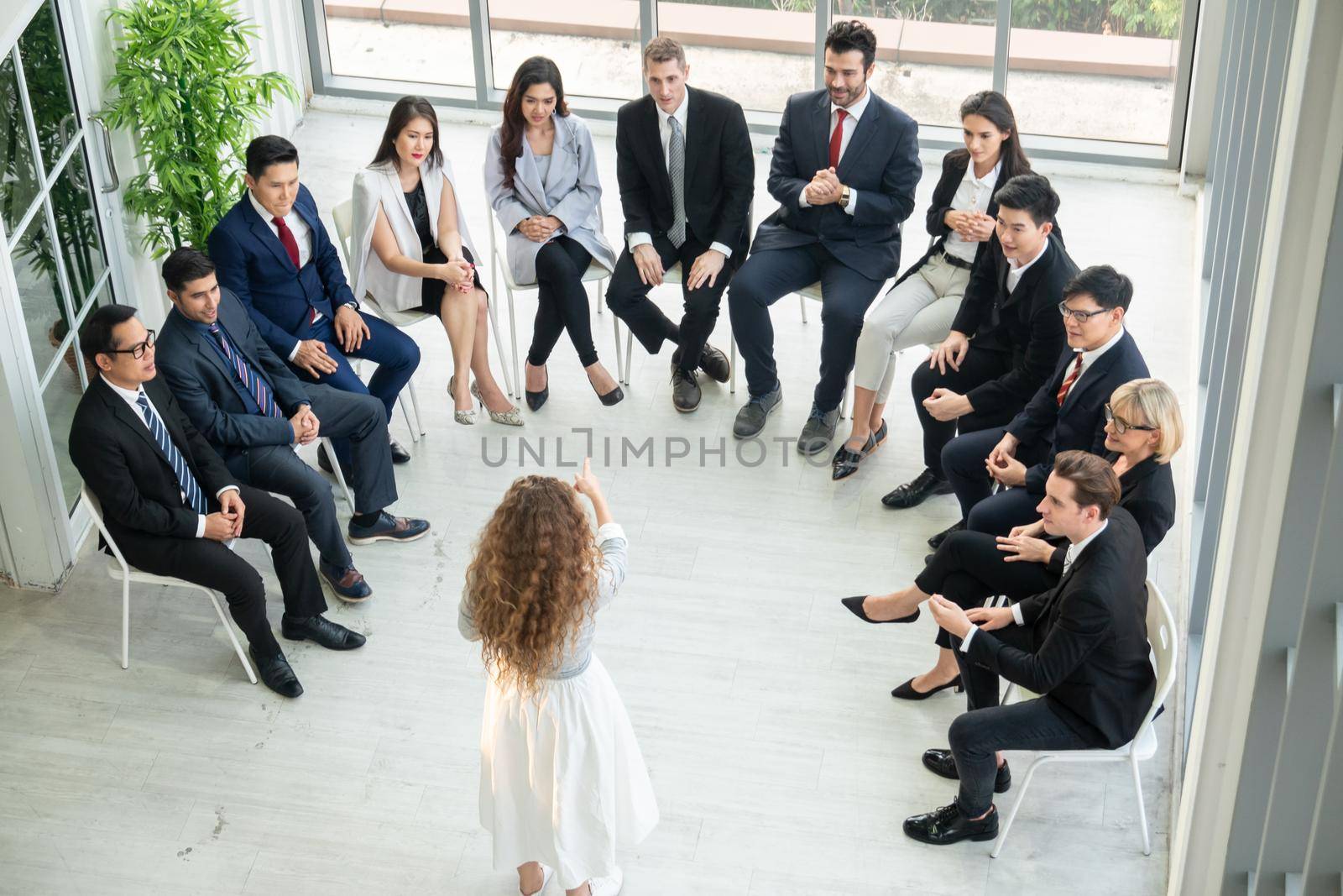 Shot of a group of businesspeople having a discussion in an office  by chuanchai