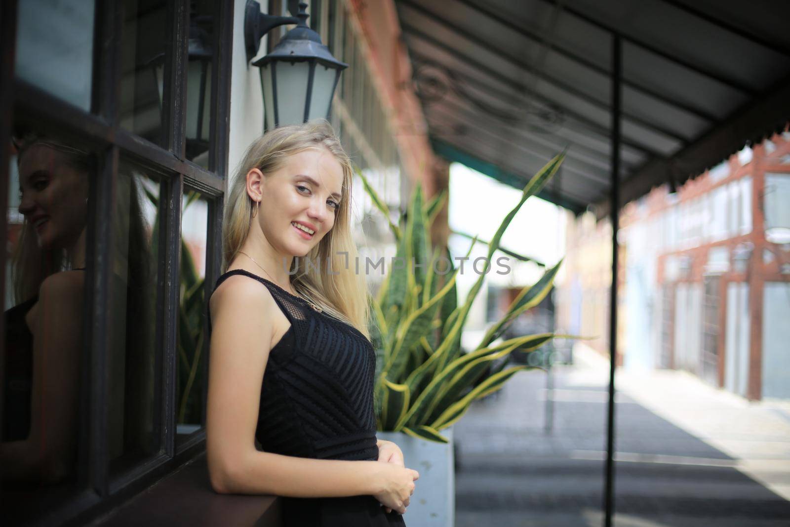 Portrait of Beautiful blonde hair girl on black dress as fashion portrait outdoor by chuanchai