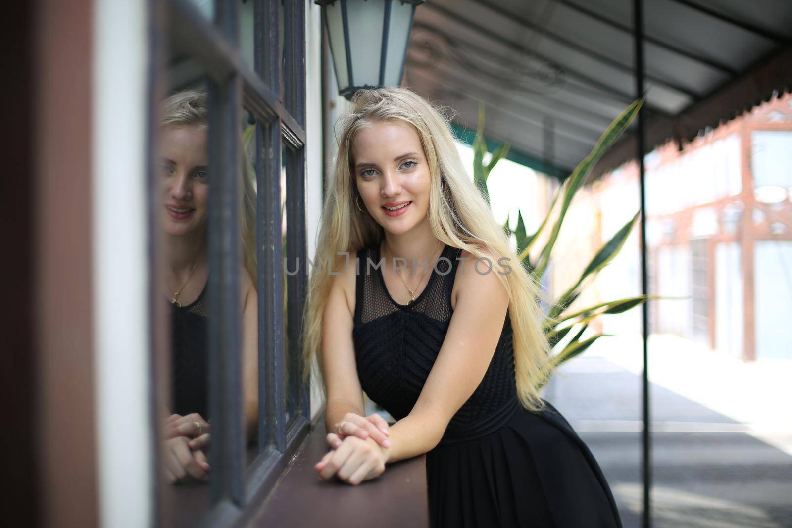 Portrait of Beautiful blonde hair girl on black dress as fashion portrait outdoor by chuanchai