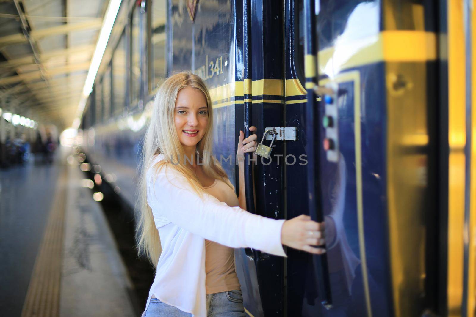 young woman waiting in vintage train, relaxed and carefree at the station platform in Bangkok, Thailand before catching a train. Travel photography. Lifestyle. by chuanchai