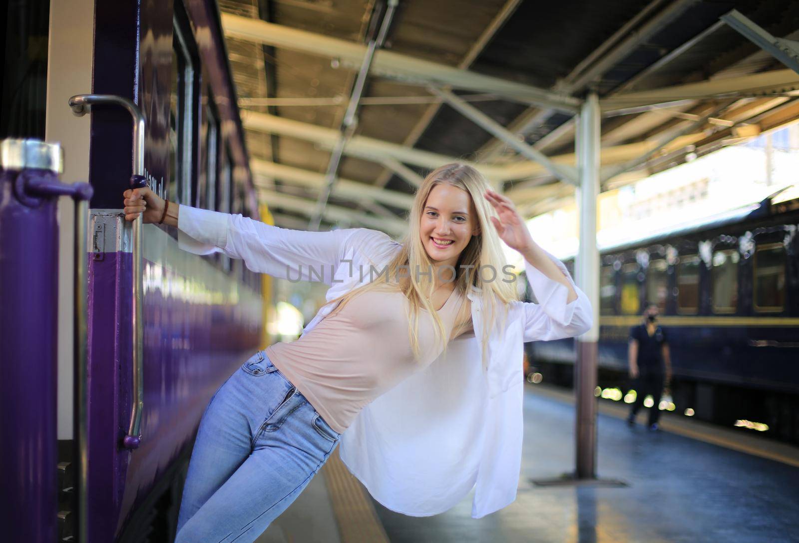 young woman waiting in vintage train, relaxed and carefree at the station platform in Bangkok, Thailand before catching a train. Travel photography. Lifestyle. by chuanchai