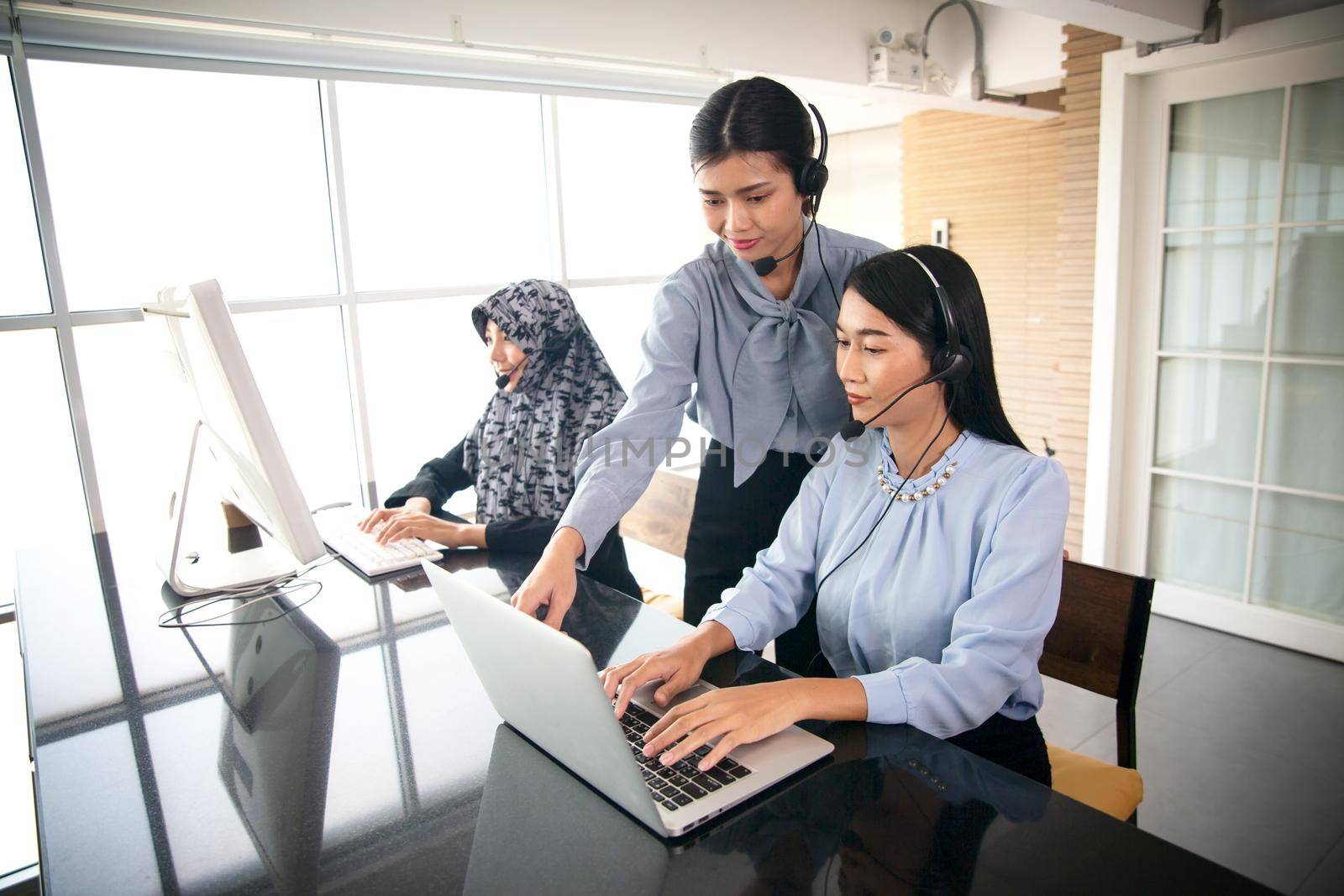 Colleagues working in a call center. by chuanchai