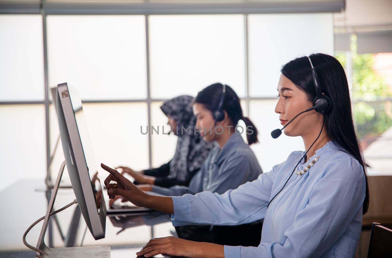 Colleagues working in a call center. by chuanchai