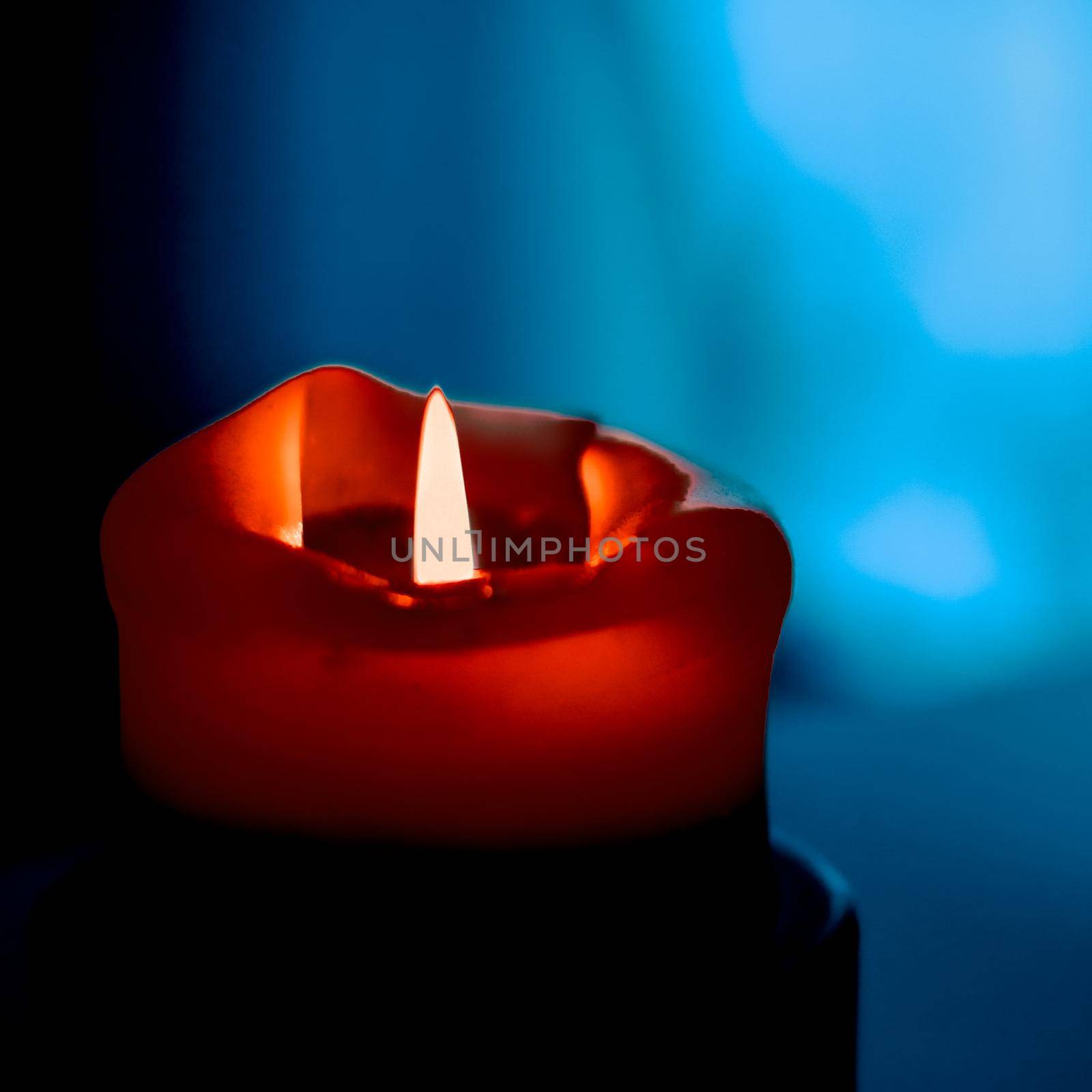 Happy holidays, greeting card backdrop and winter season concept - Red holiday candle on dark background, luxury branding design and decoration for Christmas, New Years Eve and Valentines Day