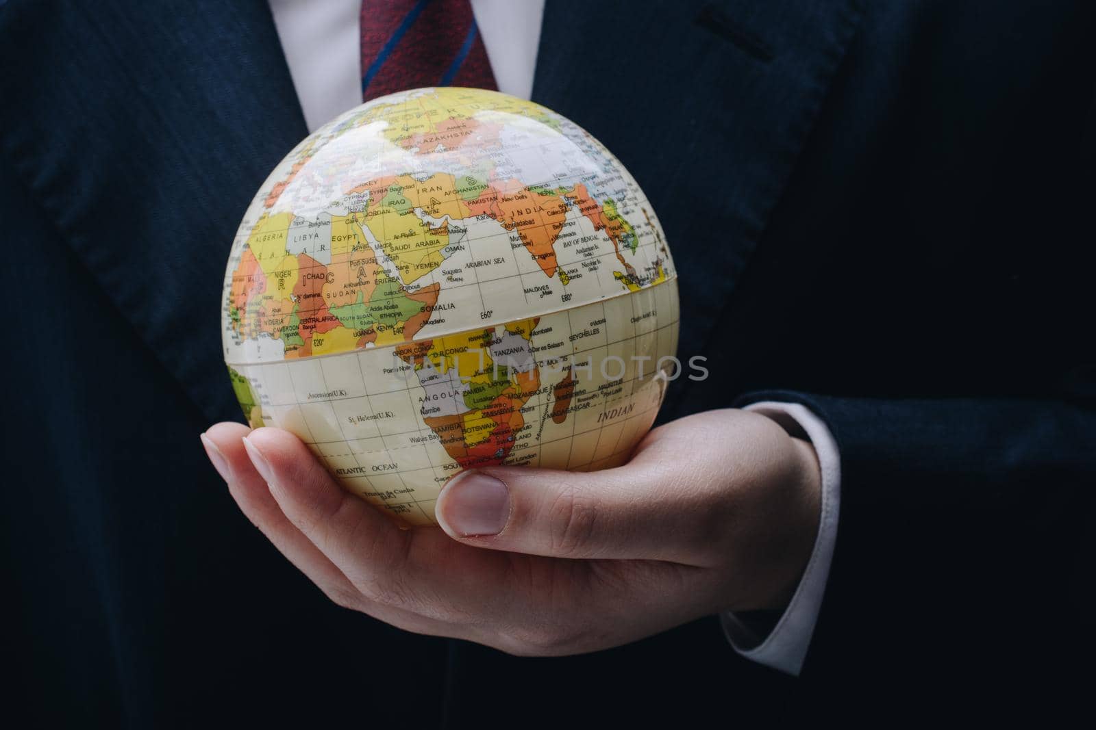 Businessman is standing with an earth globe fot business concept