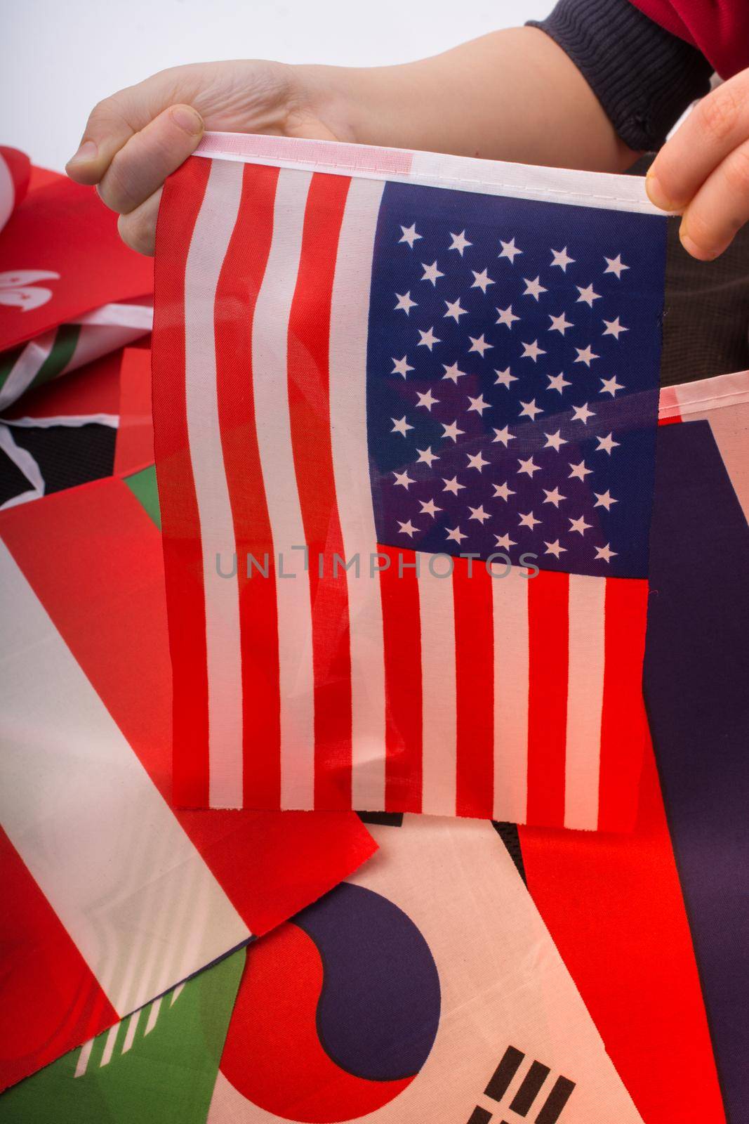 Child hand holding an American national flag in hand