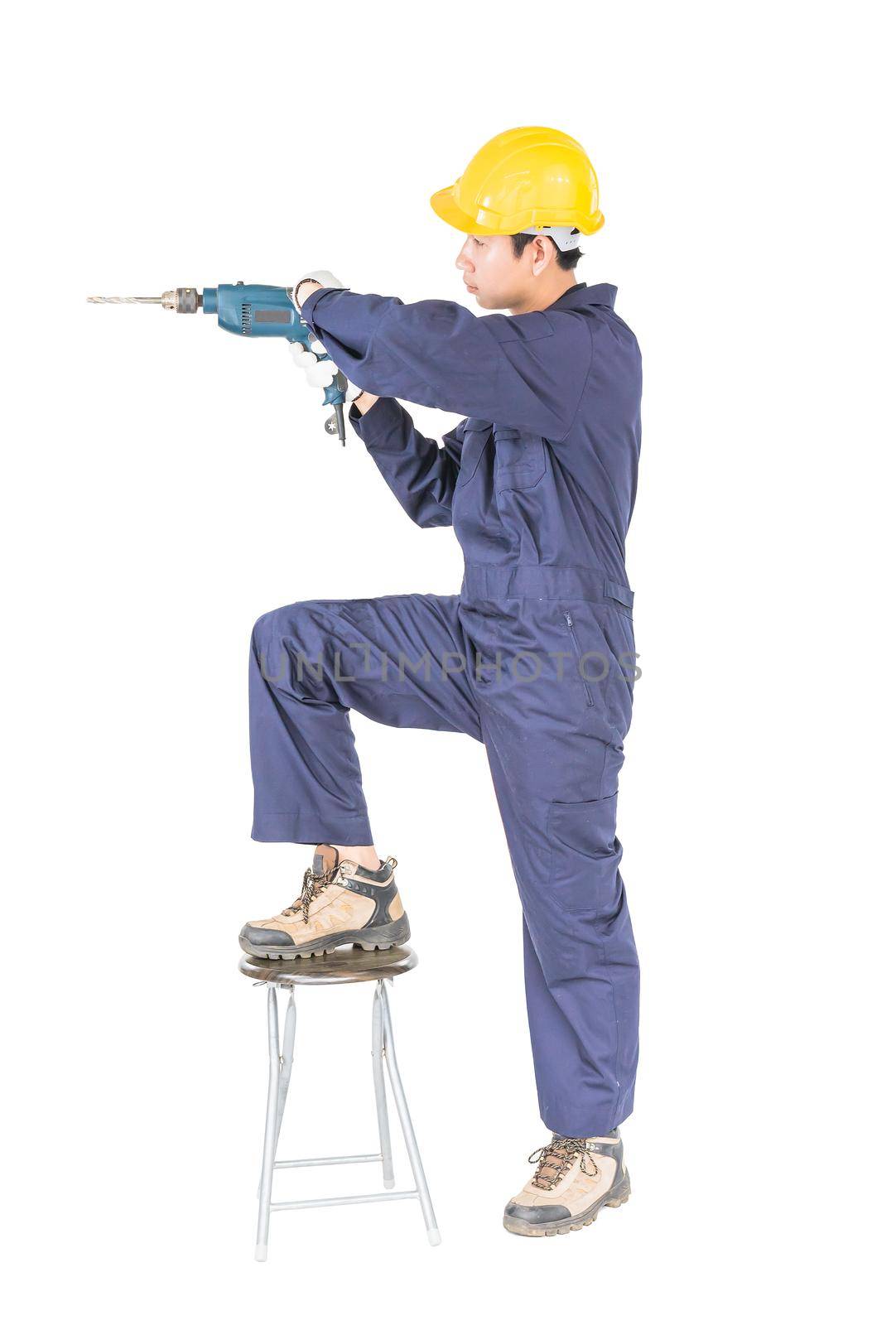 Man in unifrom standing with his electric drill, Cutout isolated on white  by stoonn