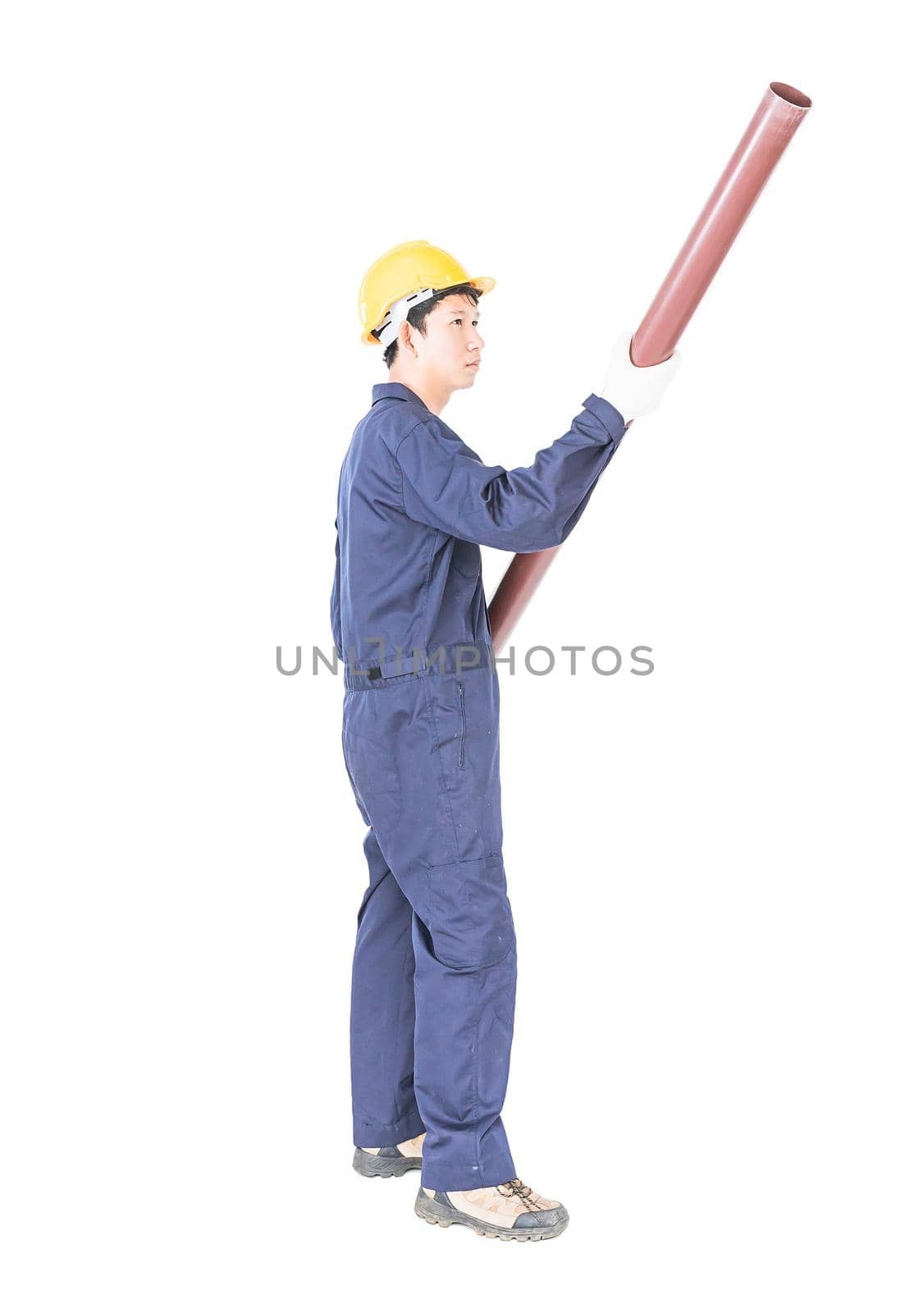 Young plumber in uniform holding pvc pipe isolated on white background  with clipping path