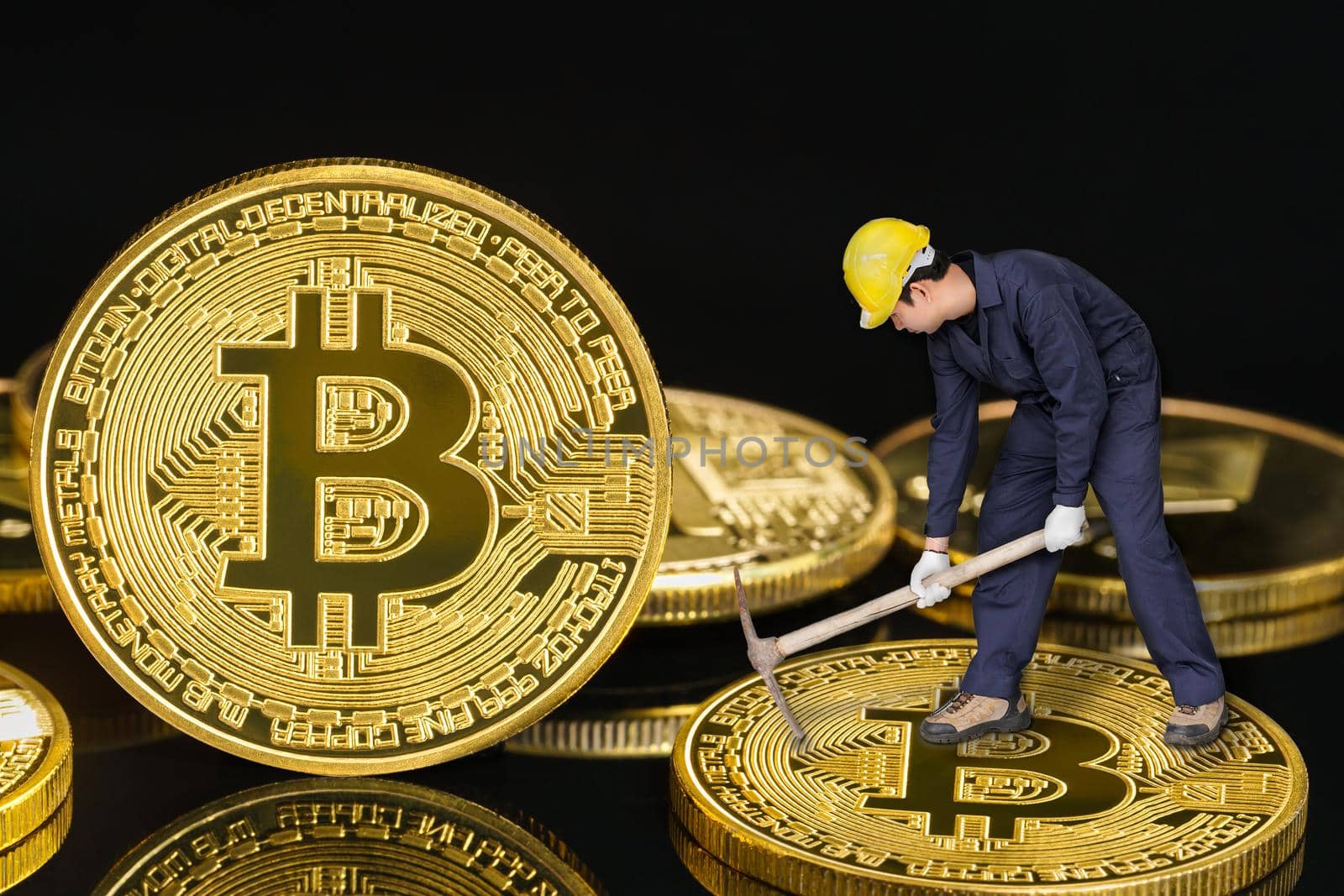 Bitcoin mining worker holding mattock digging golden Bitcoin crypto currency coin by stoonn