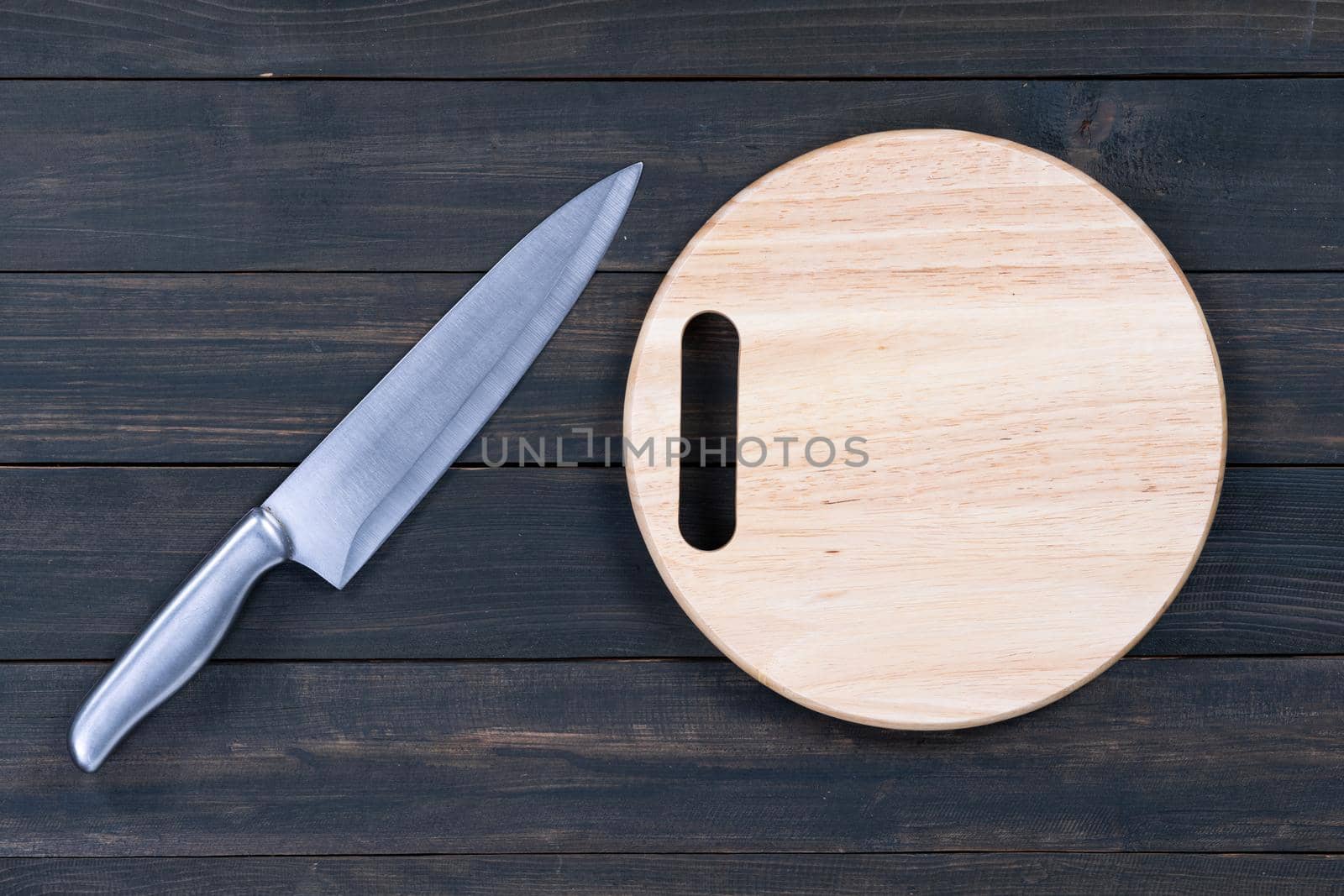 Close up kitchen knife and wooden round cutting board  by stoonn