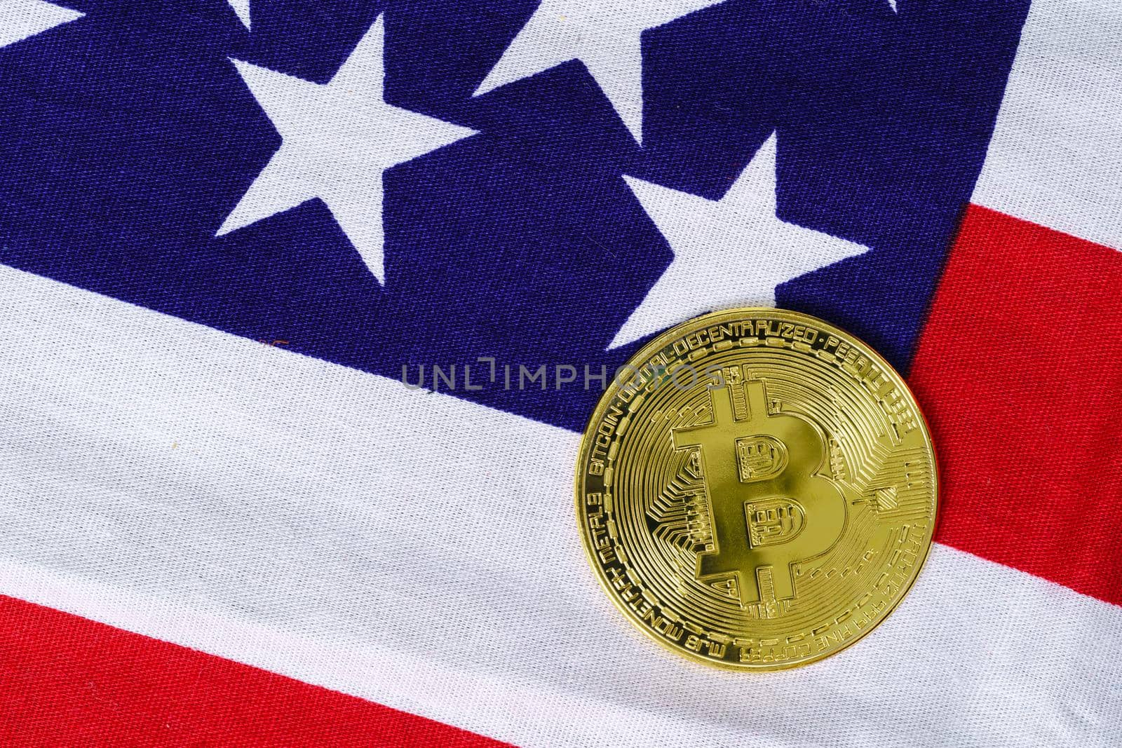 Crypto currency concept. Gold Bitcoin coin on flag of United States of America USA