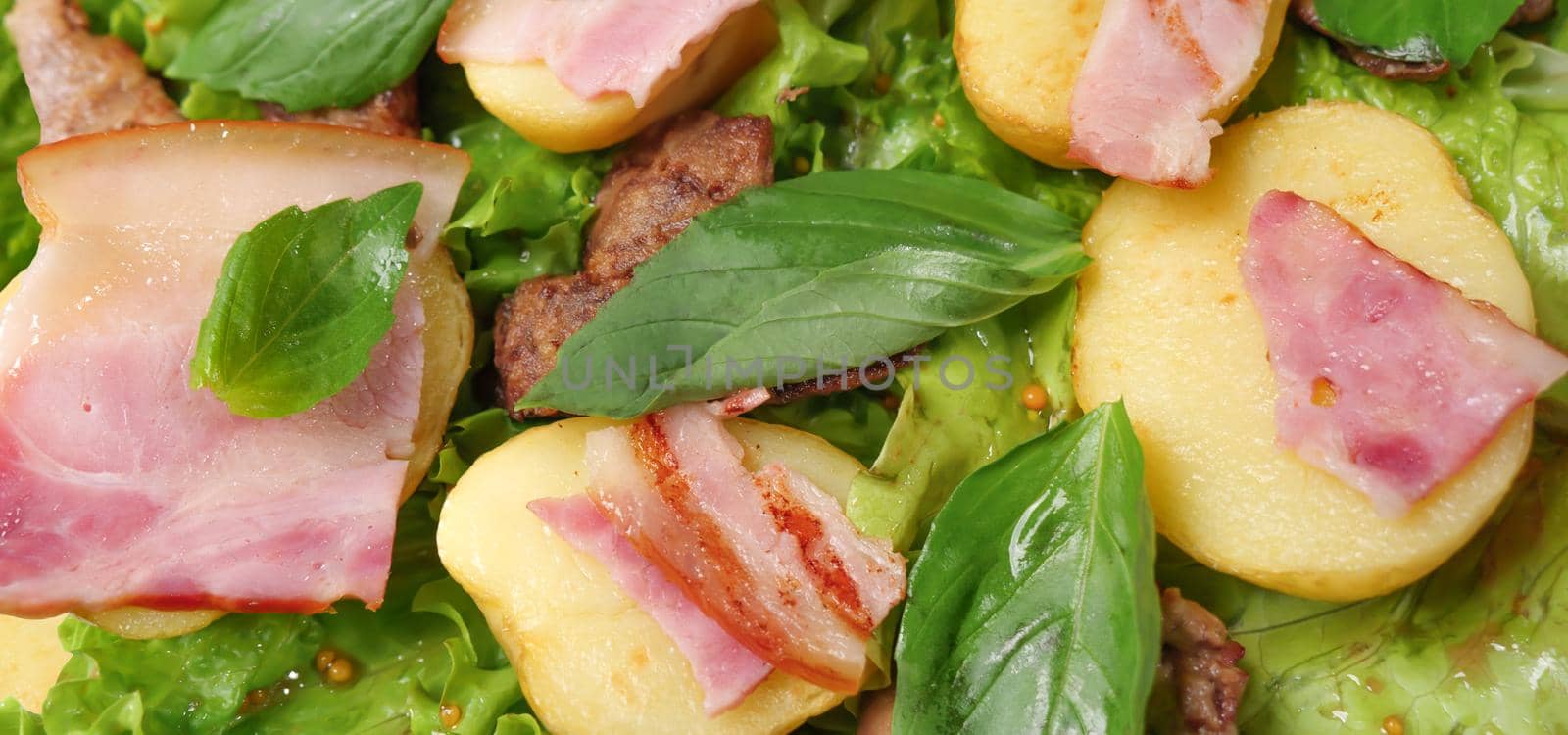 Banner food fried potatoes with meat and herbs mix. Fried bacon salad dinner dish meat. Hot salad meat and potatoes, basil, french mustard, bacon grill, lettuce leaf. Roasted potatoes dish background by synel