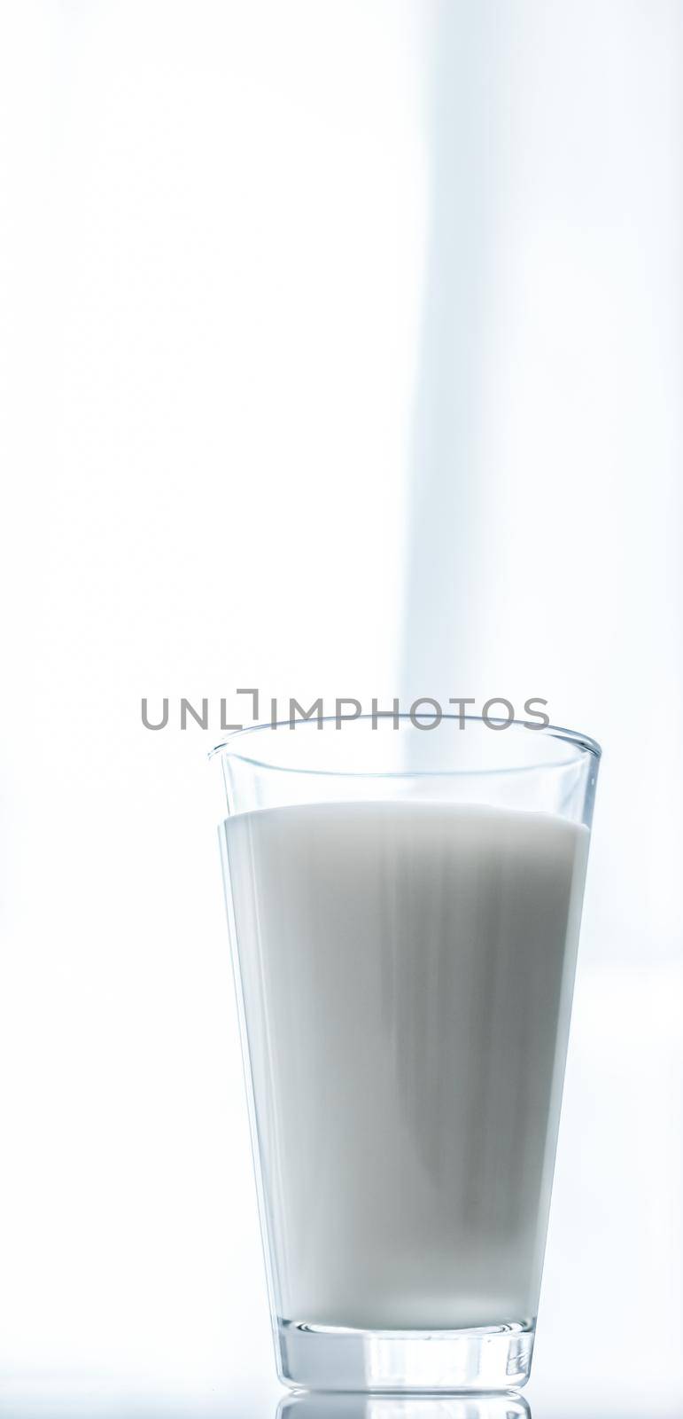 Dairy, healthy nutrition and breakfast concept - World Milk Day, full glass on marble table