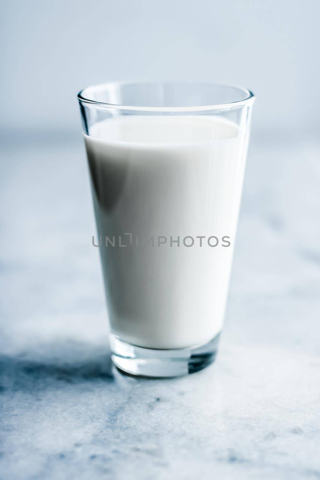 Dairy, healthy nutrition and breakfast concept - World Milk Day, full glass on marble table