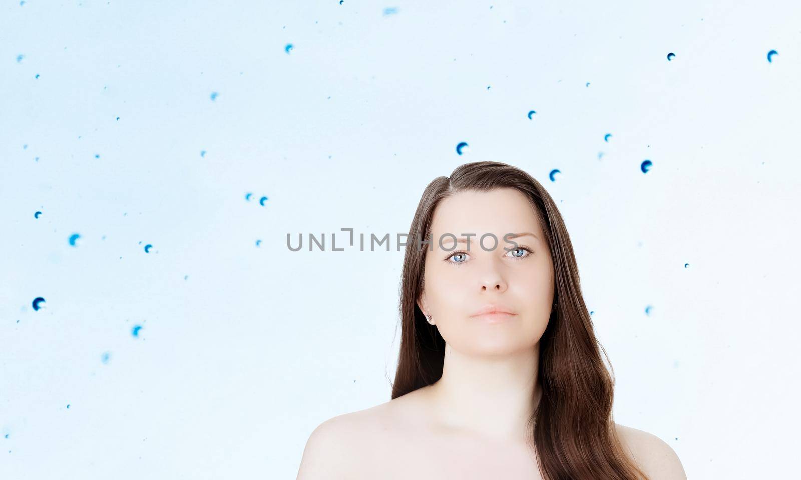 Rejuvenation skincare and beauty ad, beauty face portrait of young woman with healthy clean skin, blue cosmetic liquid drops on background.